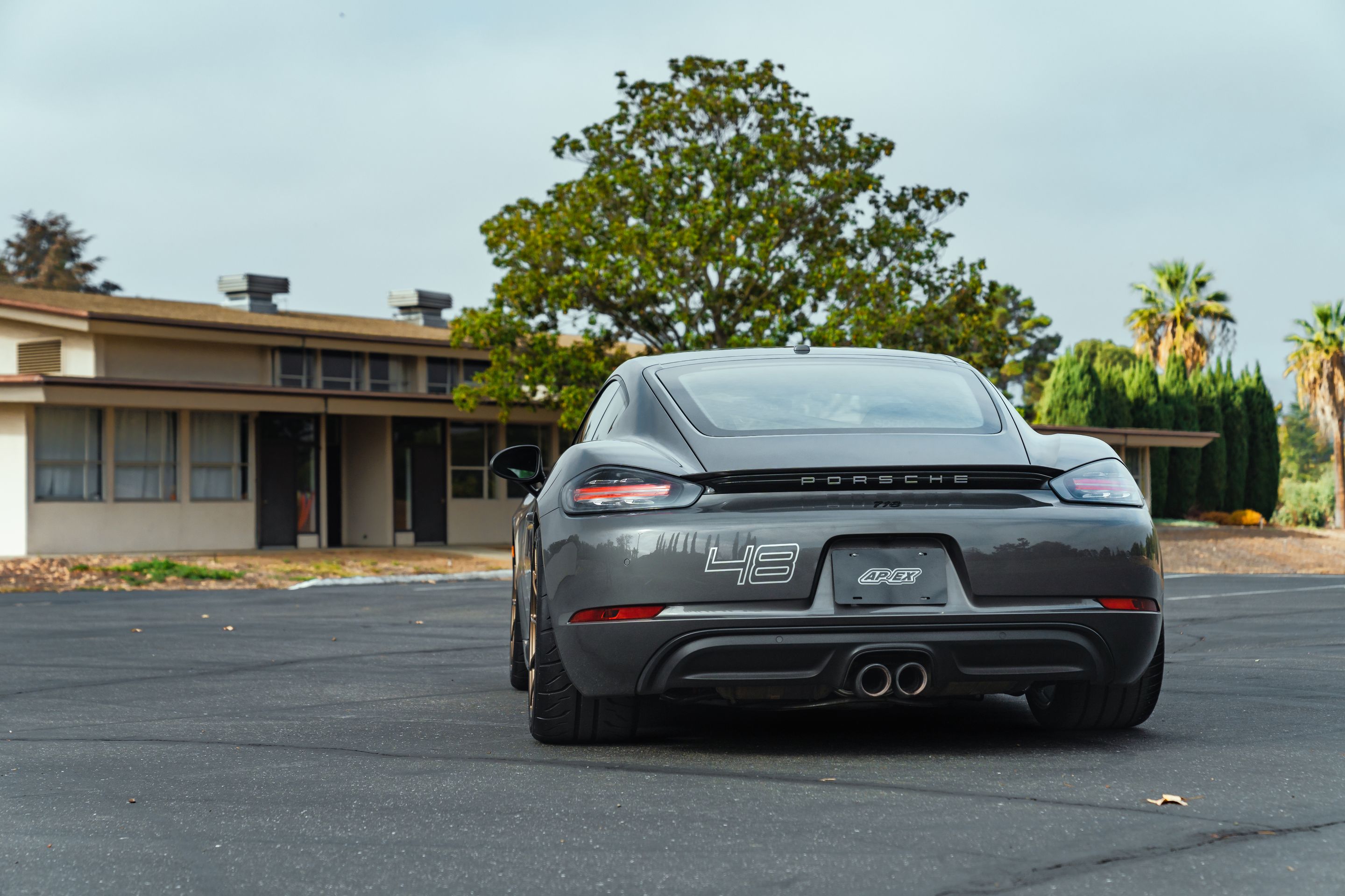 Grey Porsche 718 Cayman S with 19" SM-10RS Apex wheels in Satin Bronze