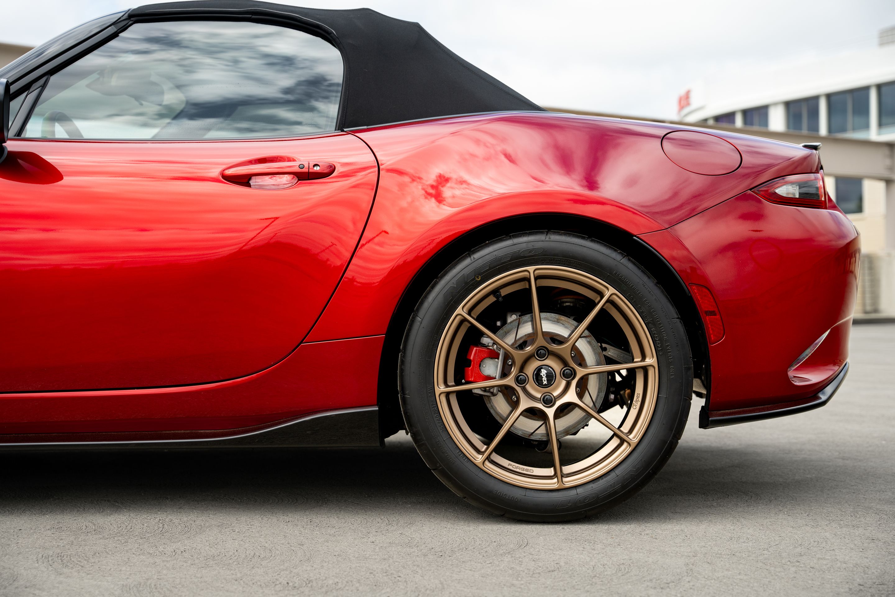 Red Mazda ND MX-5 Miata with 17" SM-8RS Apex wheels in Satin Bronze