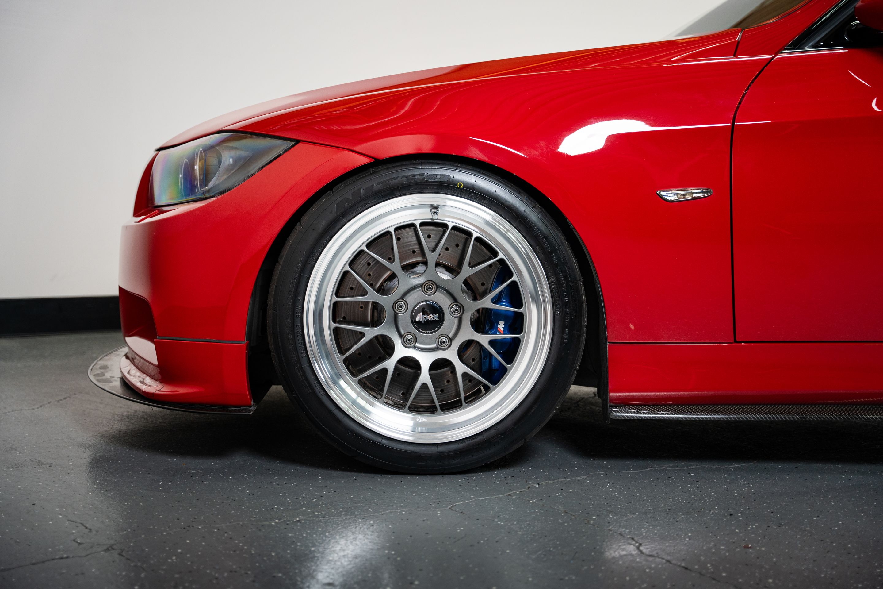Red BMW E90 Sedan 3 Series with 18" ML-10RT Apex wheels in Machined Lip Anthracite