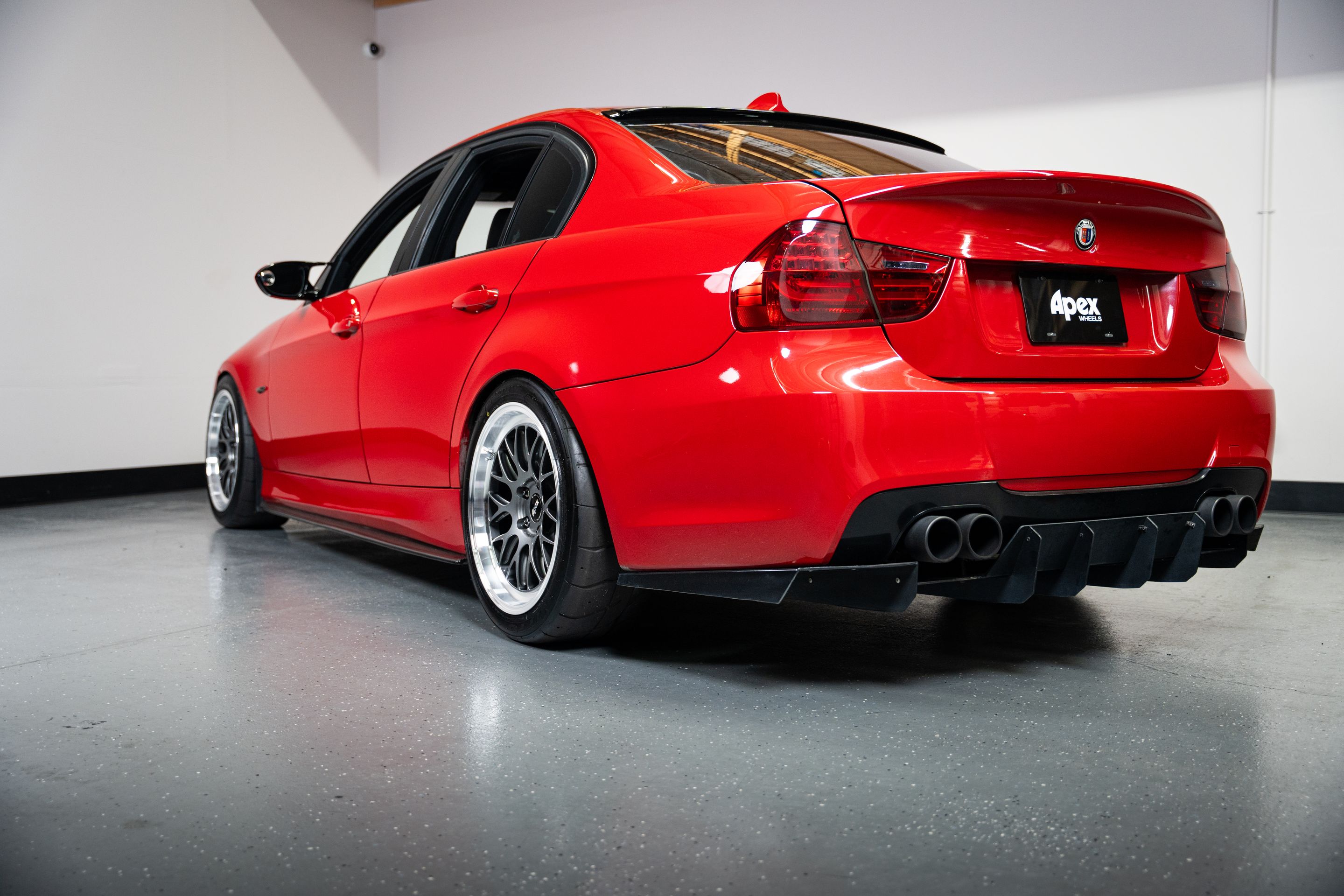Red BMW E90 Sedan 3 Series with 18" ML-10RT Apex wheels in Machined Lip Anthracite