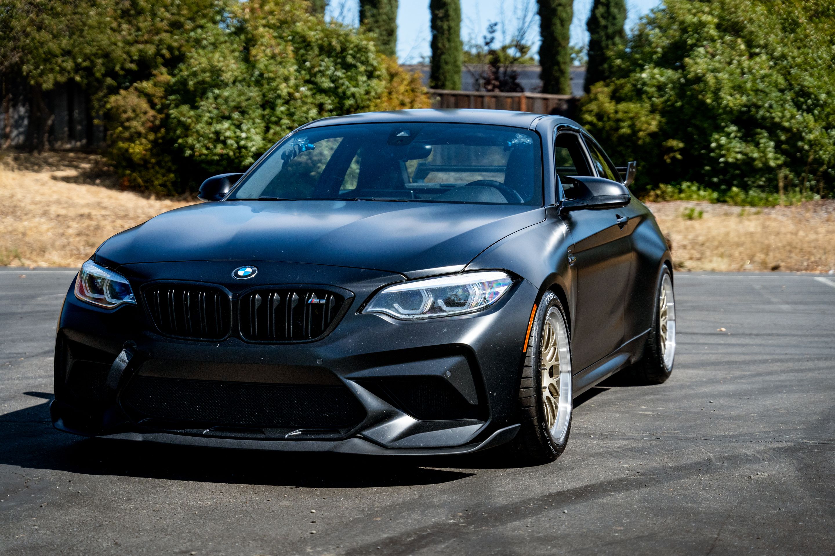 Black BMW F87 M2 with 18" ML-10RT Apex wheels in Machined Lip Gloss Motorsport Gold