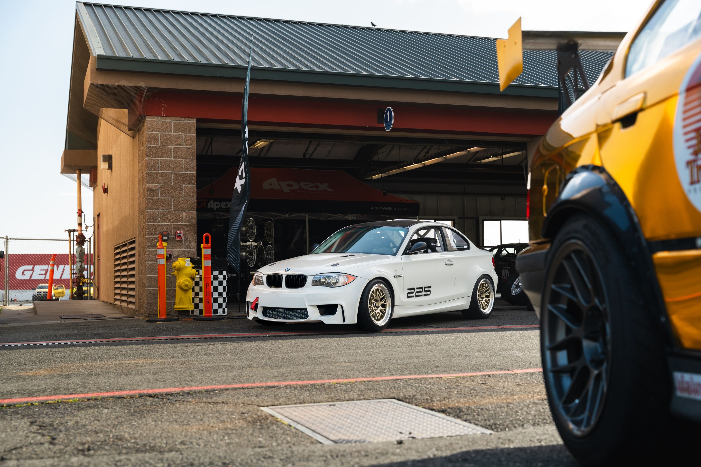 White BMW E82 1M with 18" ML-10RT Apex wheels in Machined Lip Gloss Motorsport Gold
