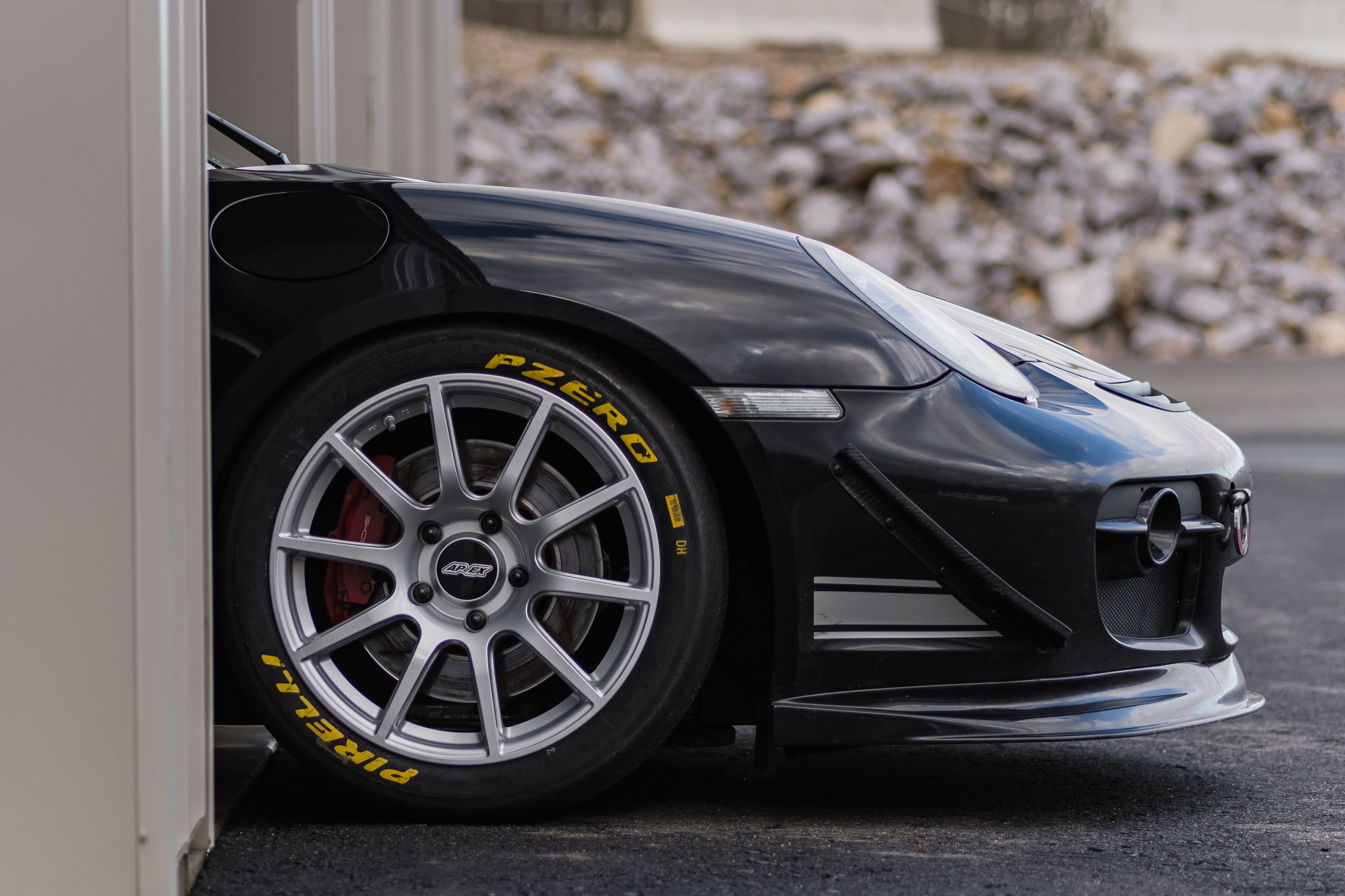 Black Porsche 987 Cayman S with 18" SM-10 Apex wheels in Race Silver