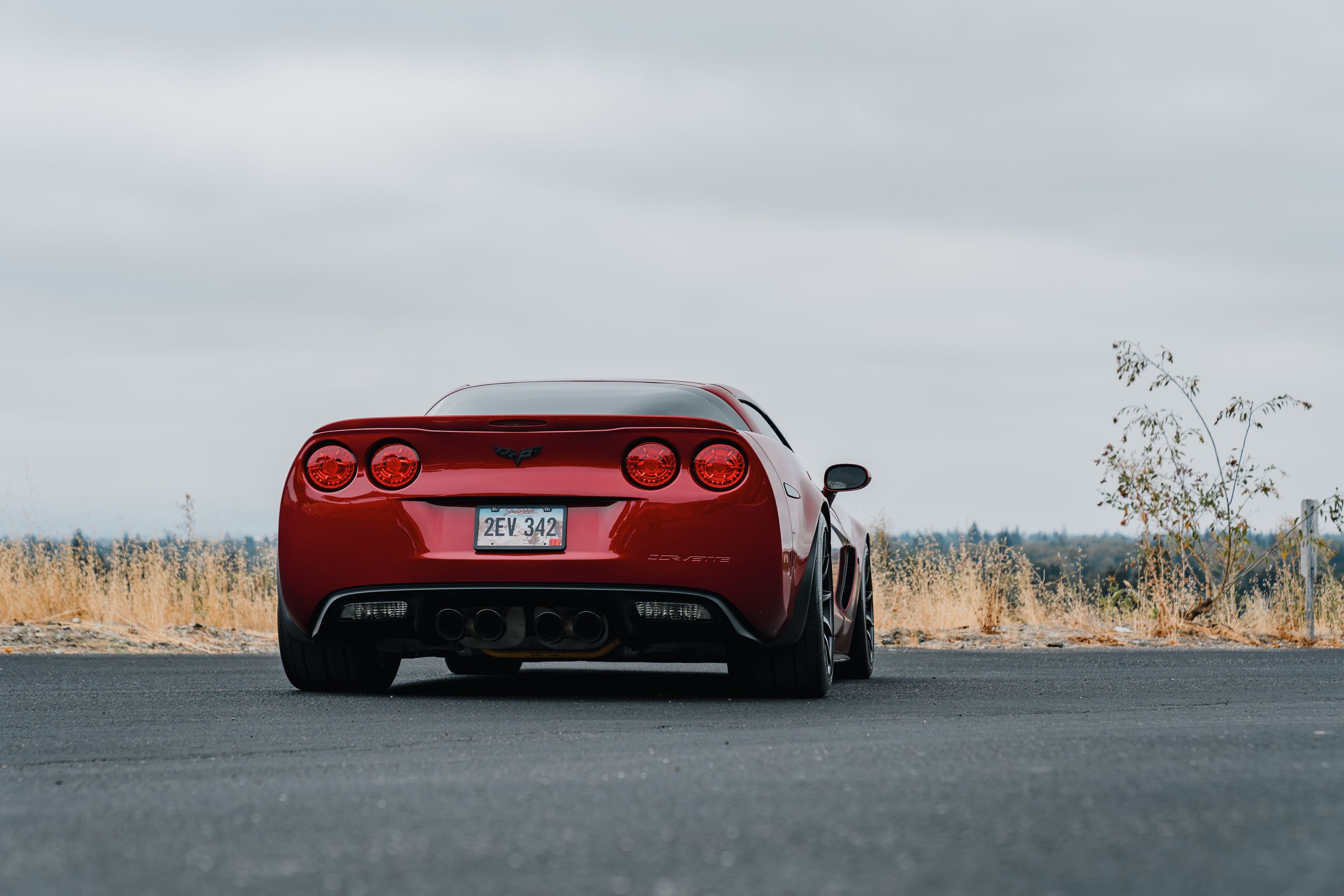 Red Chevrolet C6 Corvette Z06 with 18"/19" SM-10 Apex wheels in Satin Black