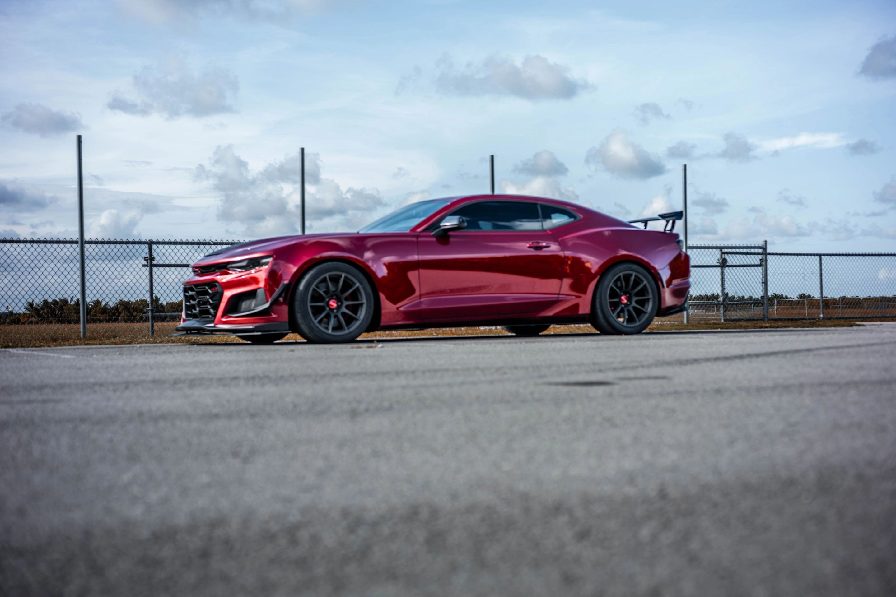Red Chevrolet 6th Gen Camaro SS with 19" SM-10 Apex wheels in Satin Black