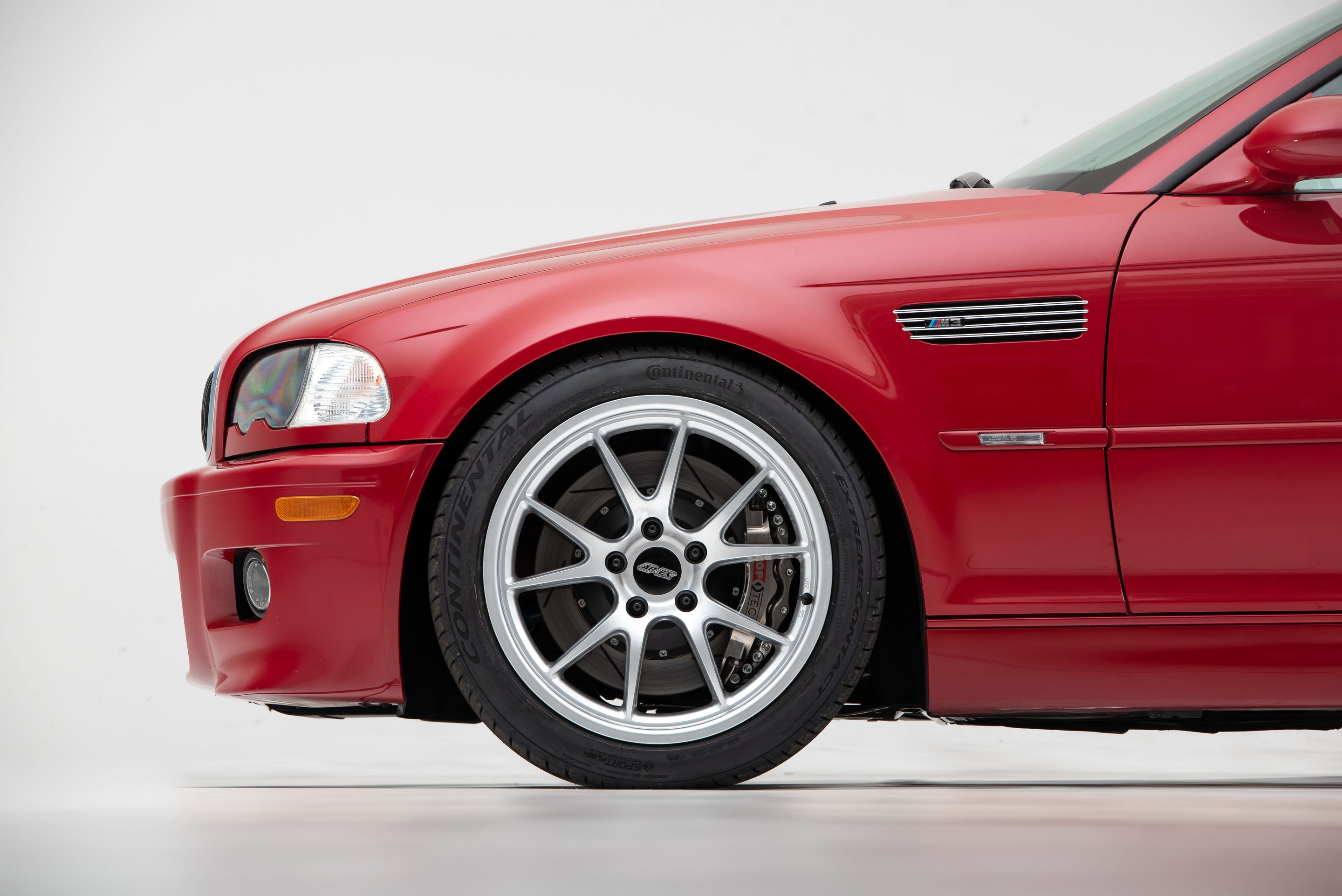 Red BMW E46 M3 with 18" FL-5 Apex wheels in Race Silver