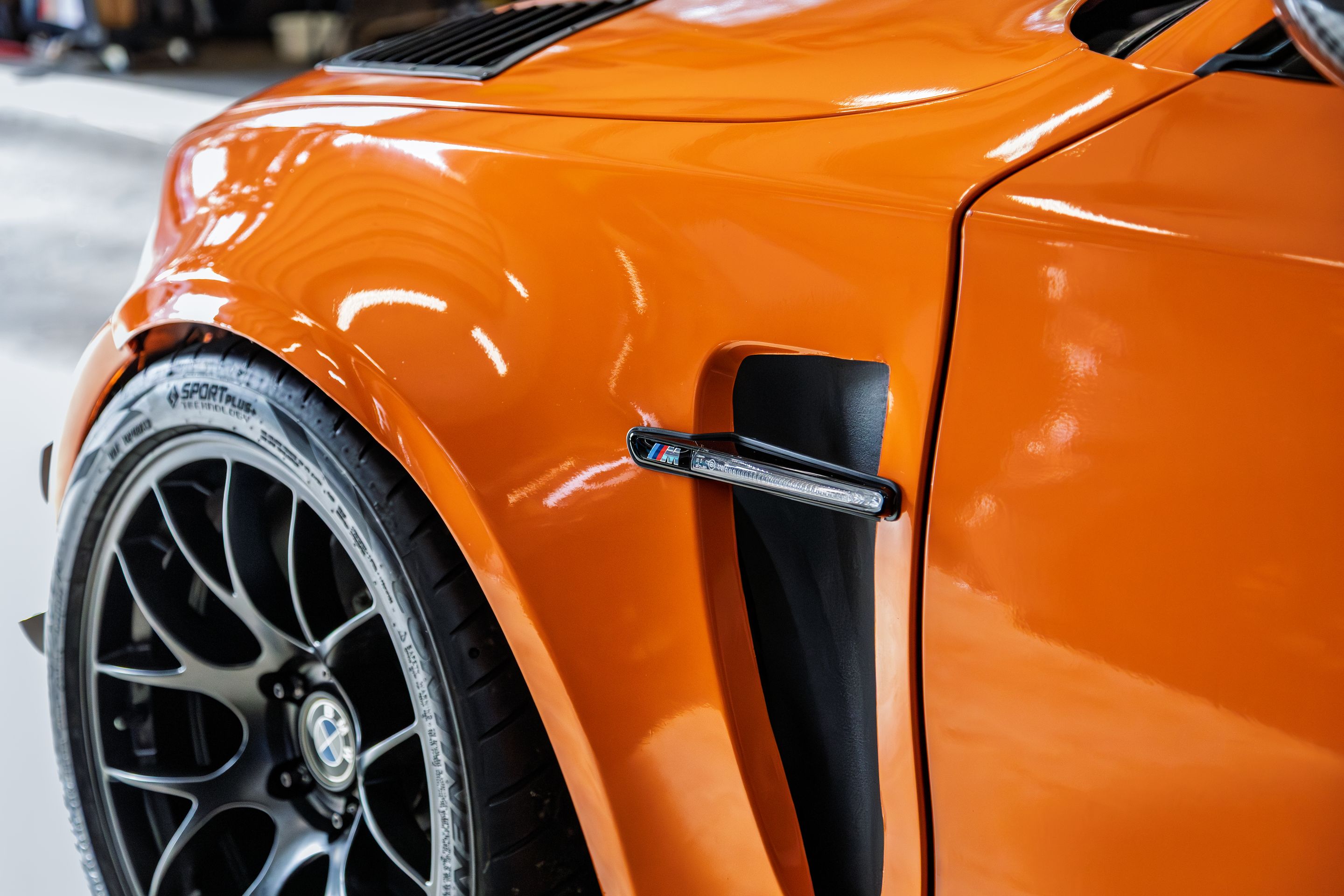 Orange BMW E82 1M with 18" EC-7 Apex wheels in Satin Black