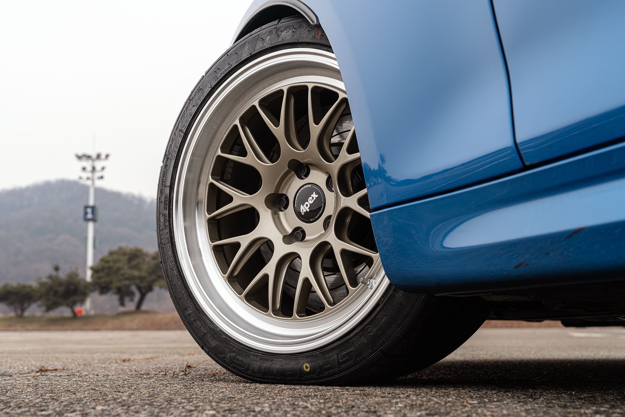 Blue BMW F87 M2 with 18" ML-10RT Apex wheels in Machined Lip Gloss Motorsport Gold