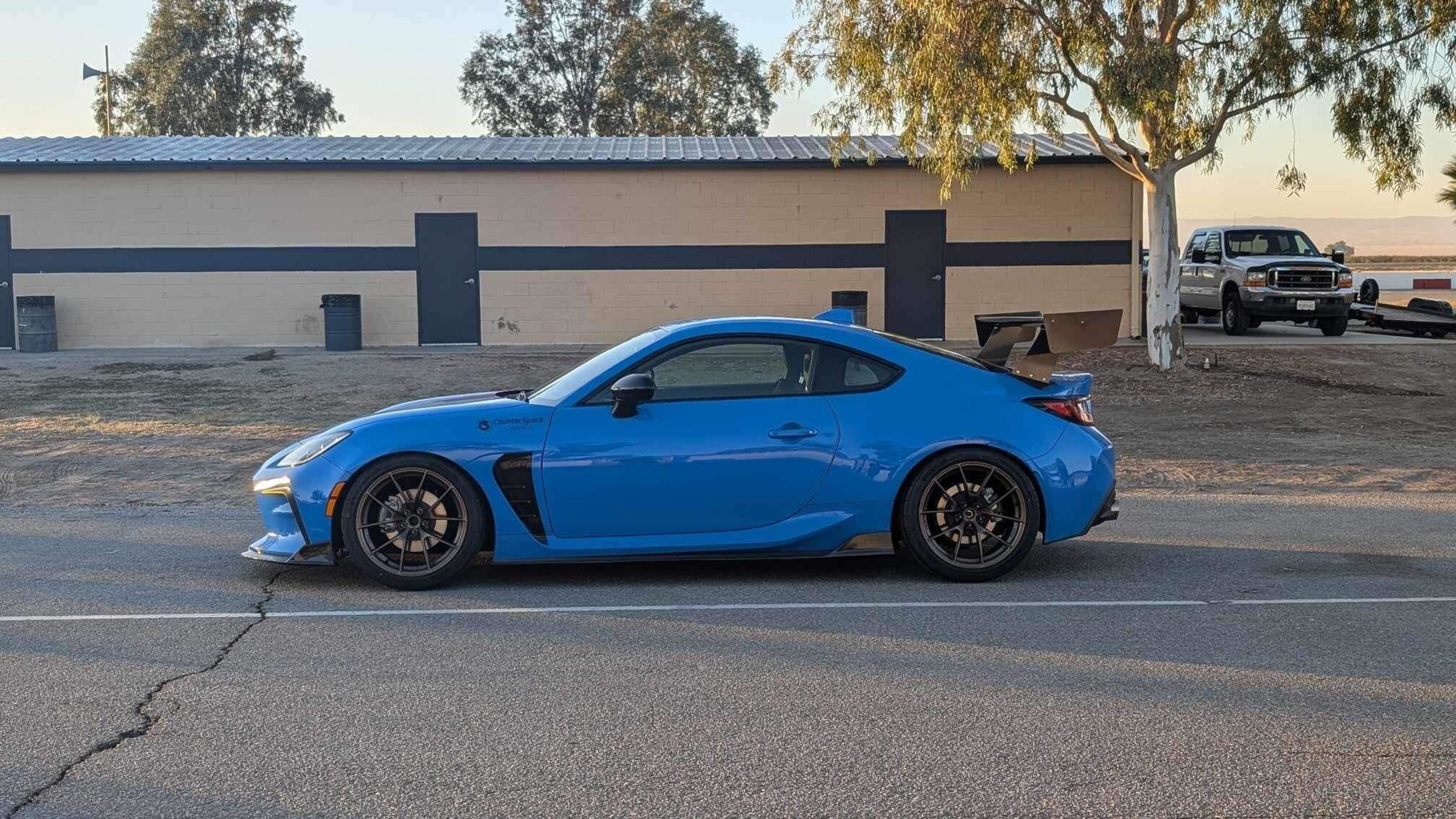 Blue Toyota GR86 with 18" VS-5RS Apex wheels in Satin Bronze