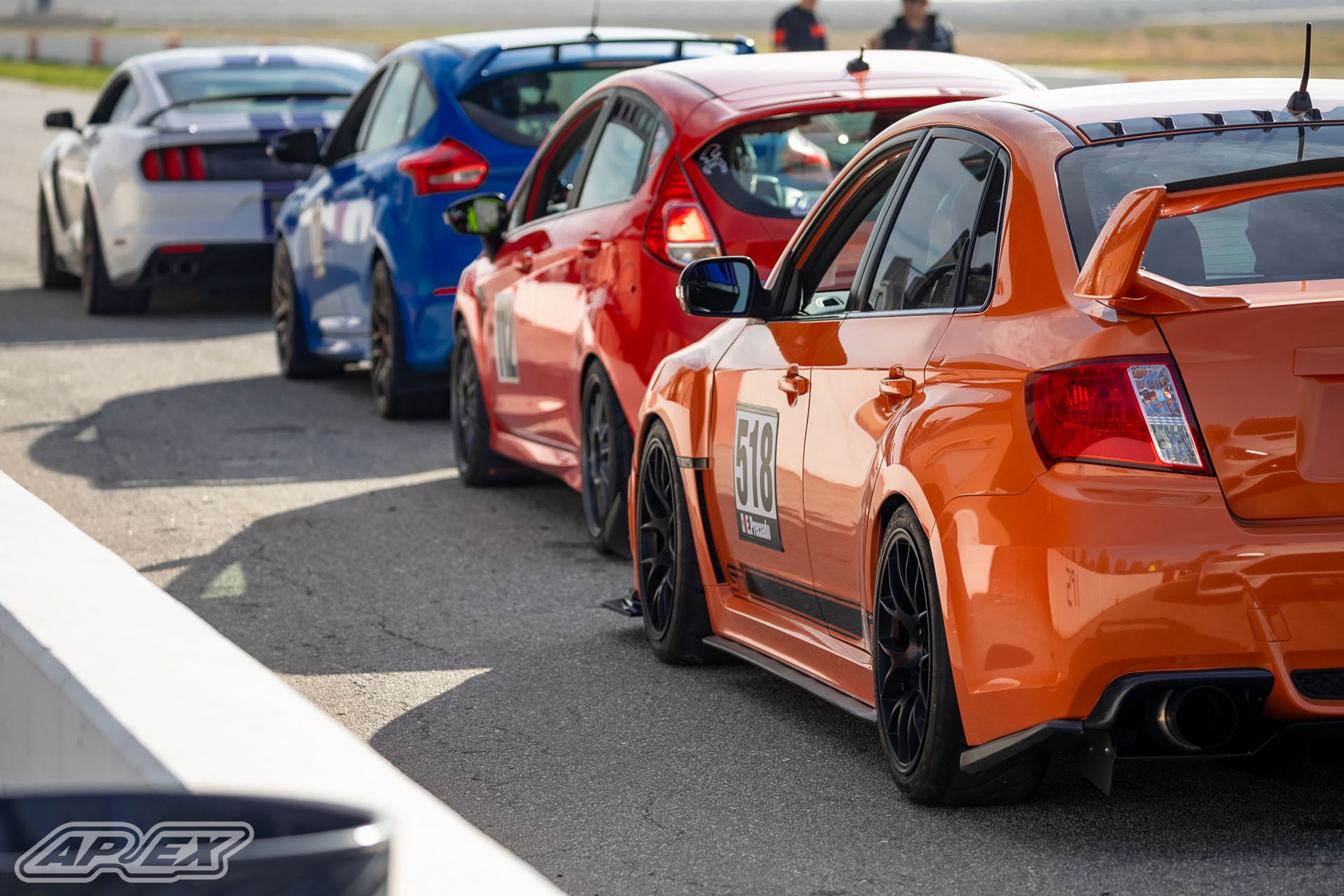 Orange Subaru GR WRX STI with 18" EC-7 Apex wheels in Satin Black