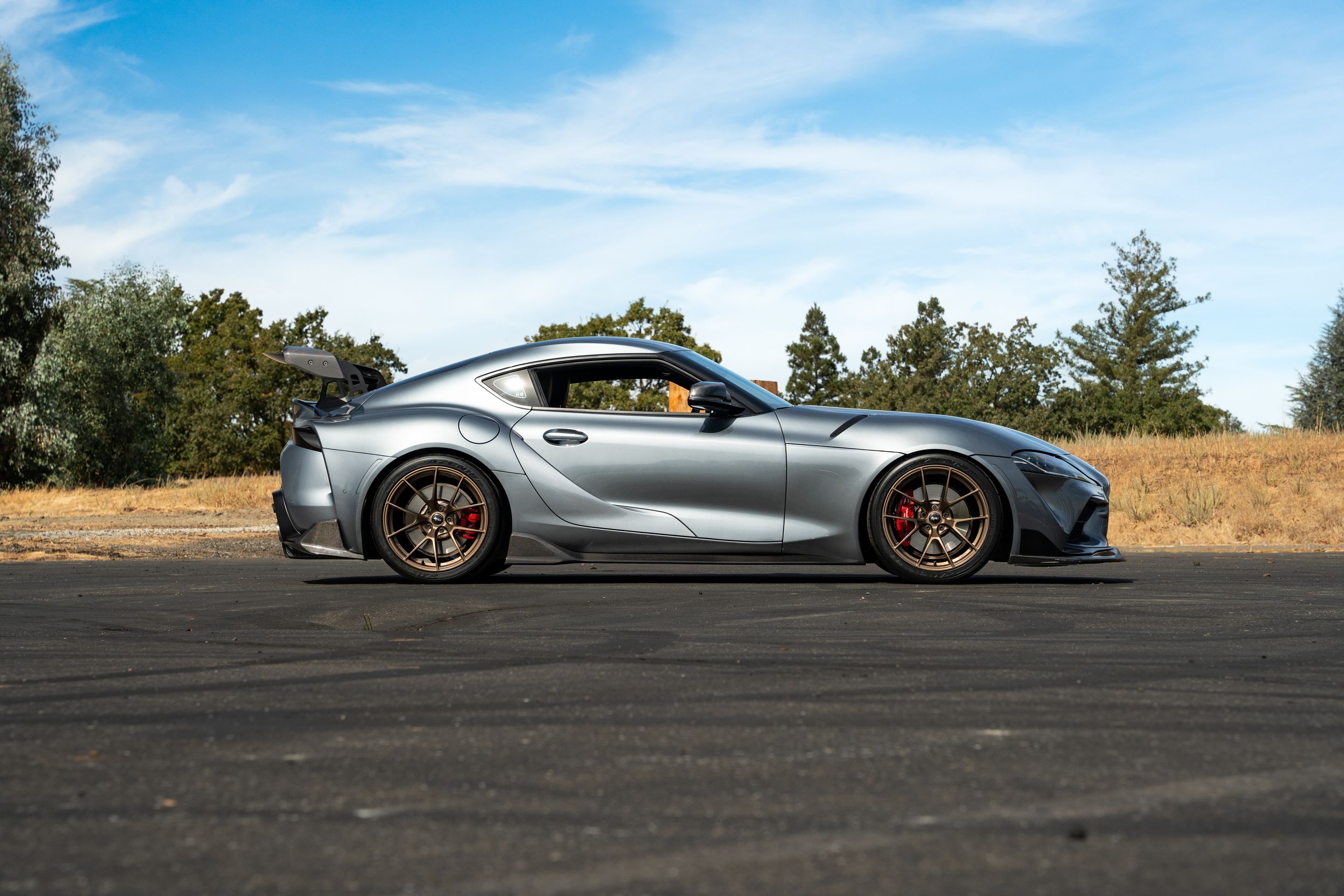 Grey Toyota GR Supra with 19" VS-5RS Apex wheels in Satin Bronze