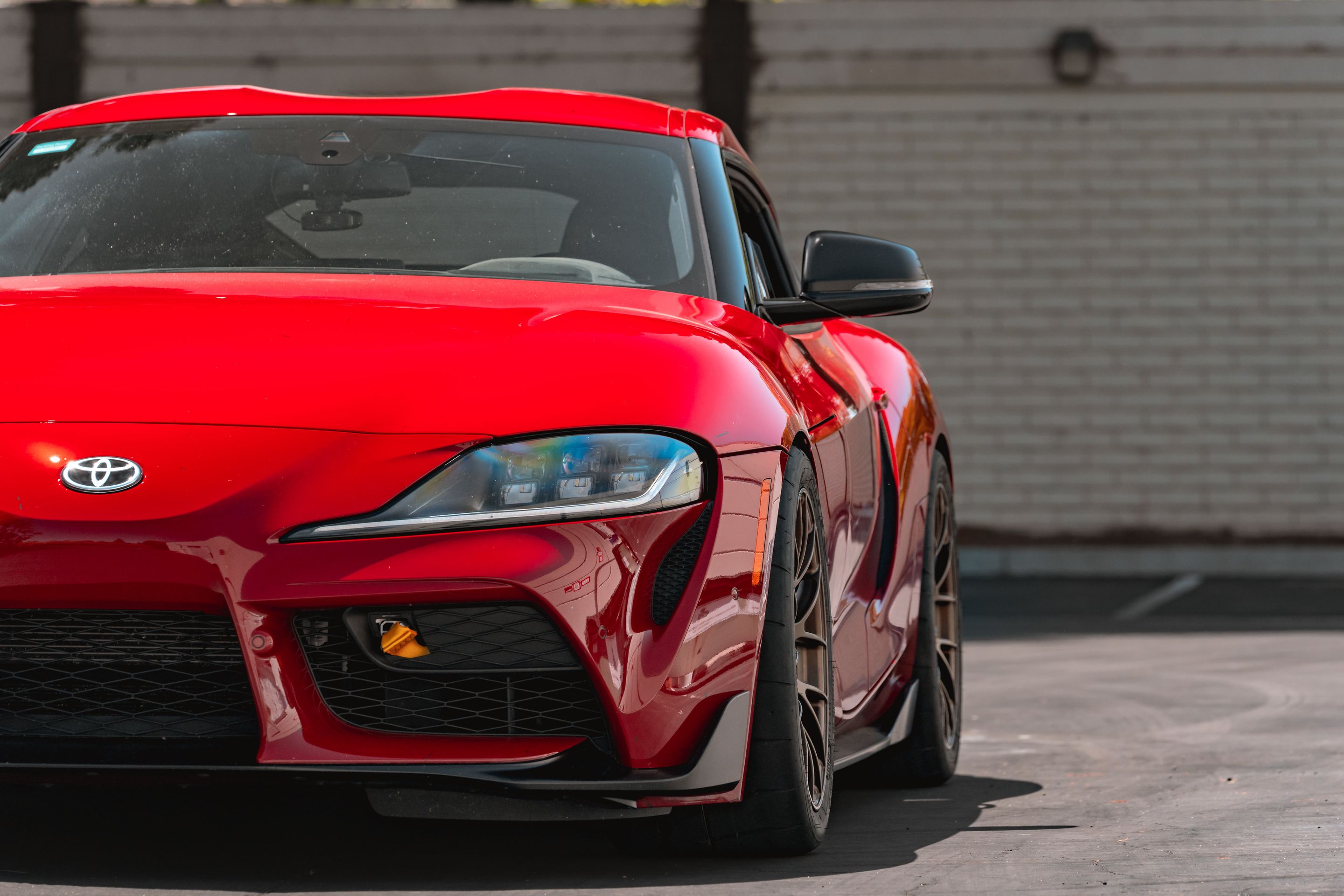 Red Toyota GR Supra with 18" EC-7RS Apex wheels in Satin Bronze