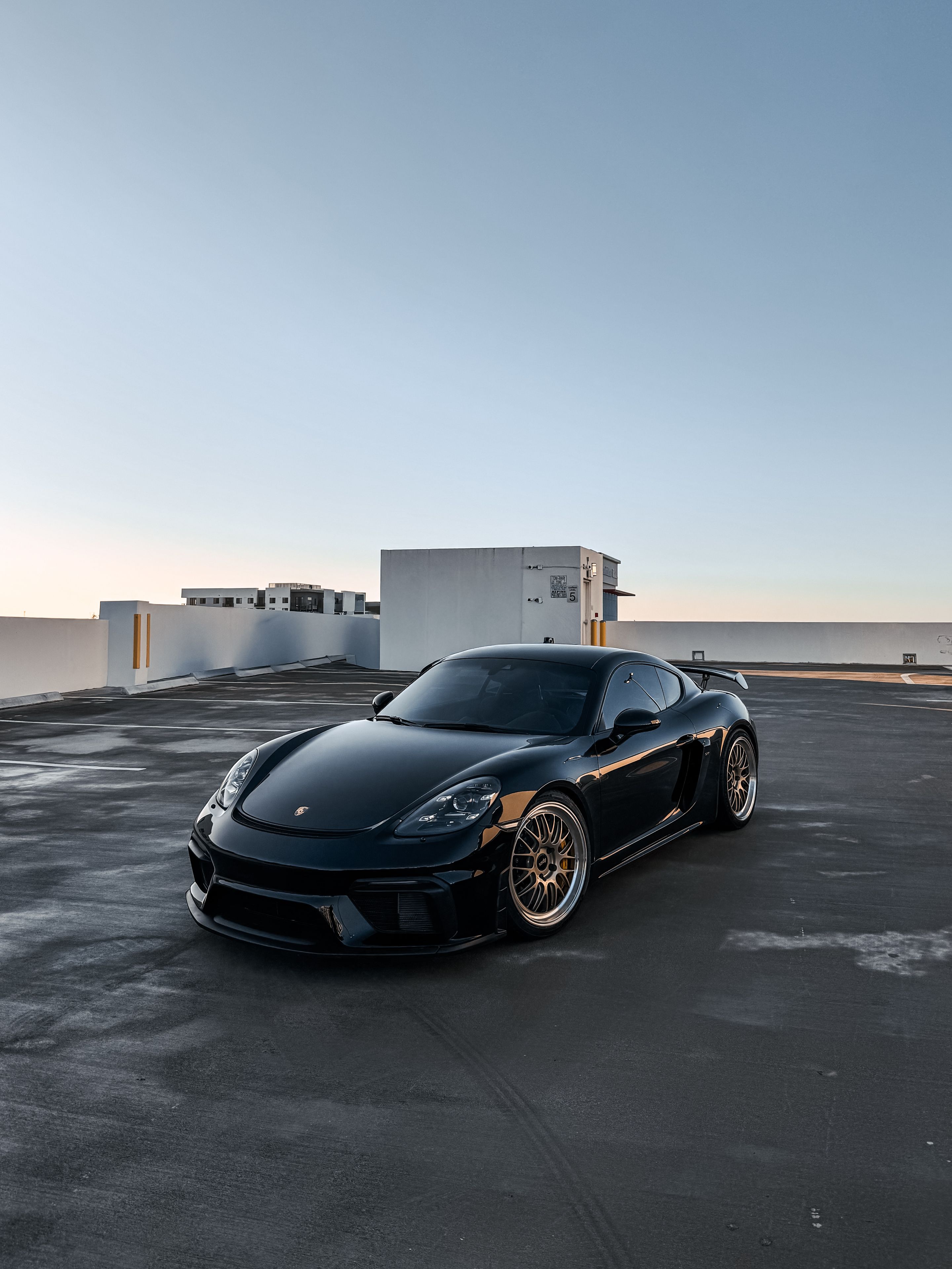 Black Porsche 718 Cayman GT4 with 20" ML-10RT Apex wheels in Machined Lip Gloss Motorsport Gold