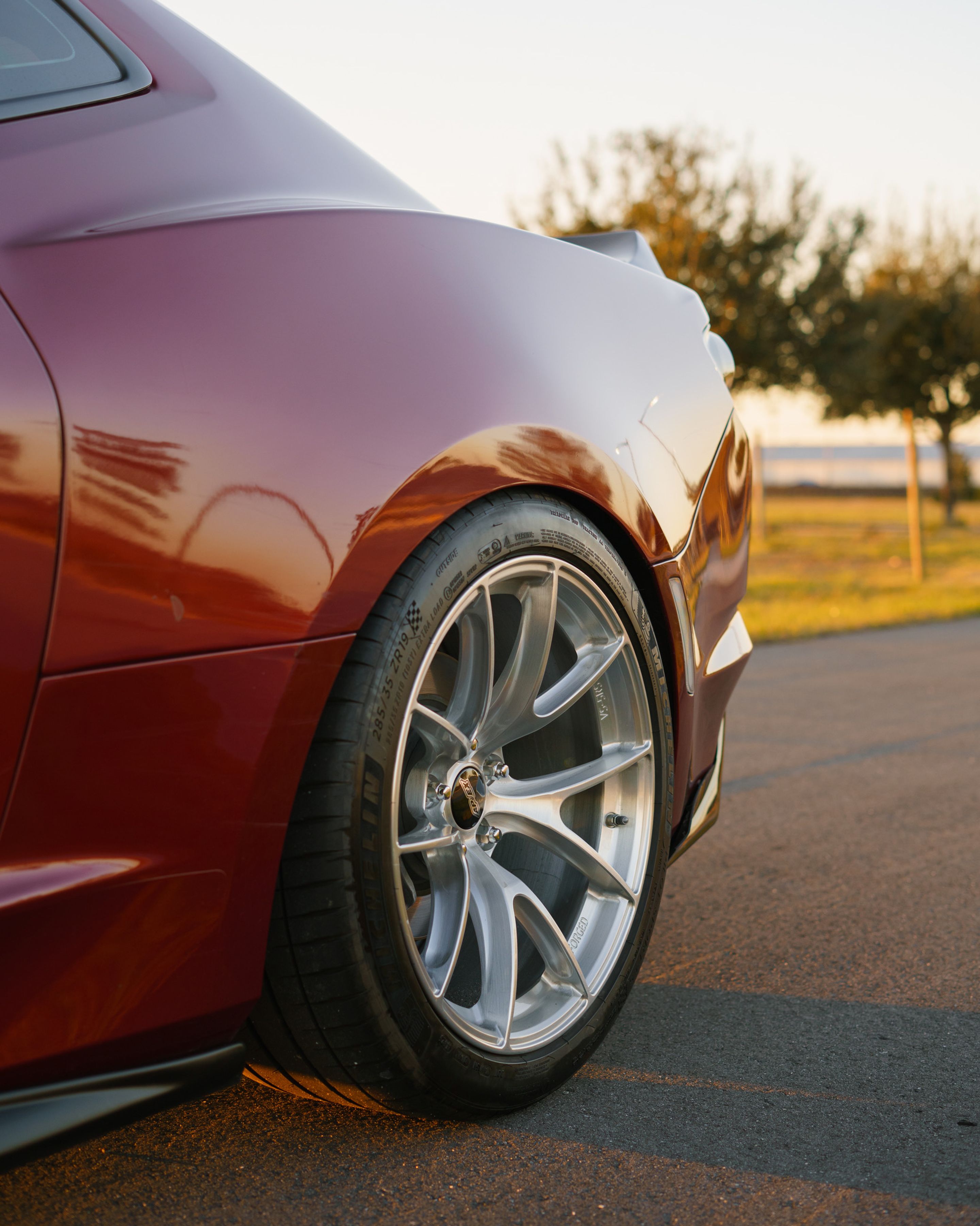 Red Chevrolet 6th Gen Camaro LT1 with 19" VS-5RS Apex wheels in Brushed Clear
