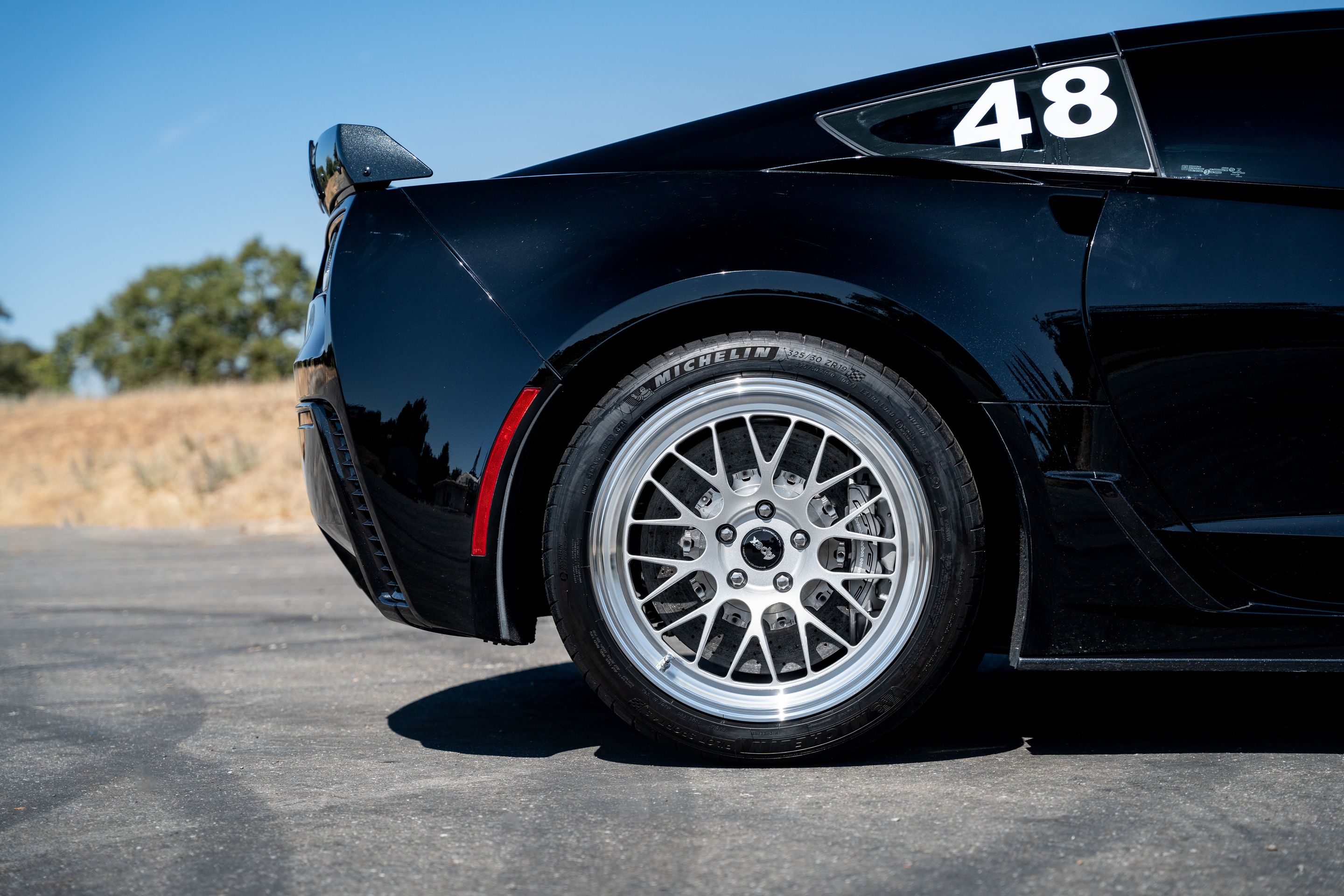 Black Chevrolet C7 Corvette Z06 with 18"/19" ML-10RT Apex wheels in Machined Lip Race Silver