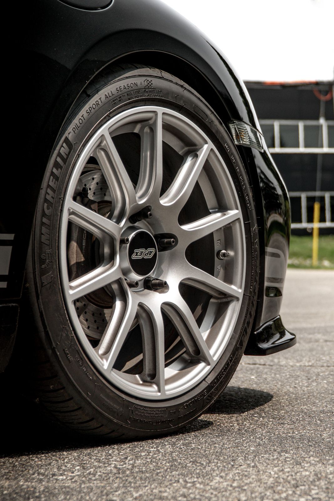 Black Porsche 987 Cayman Base with 18" SM-10 Apex wheels in Race Silver