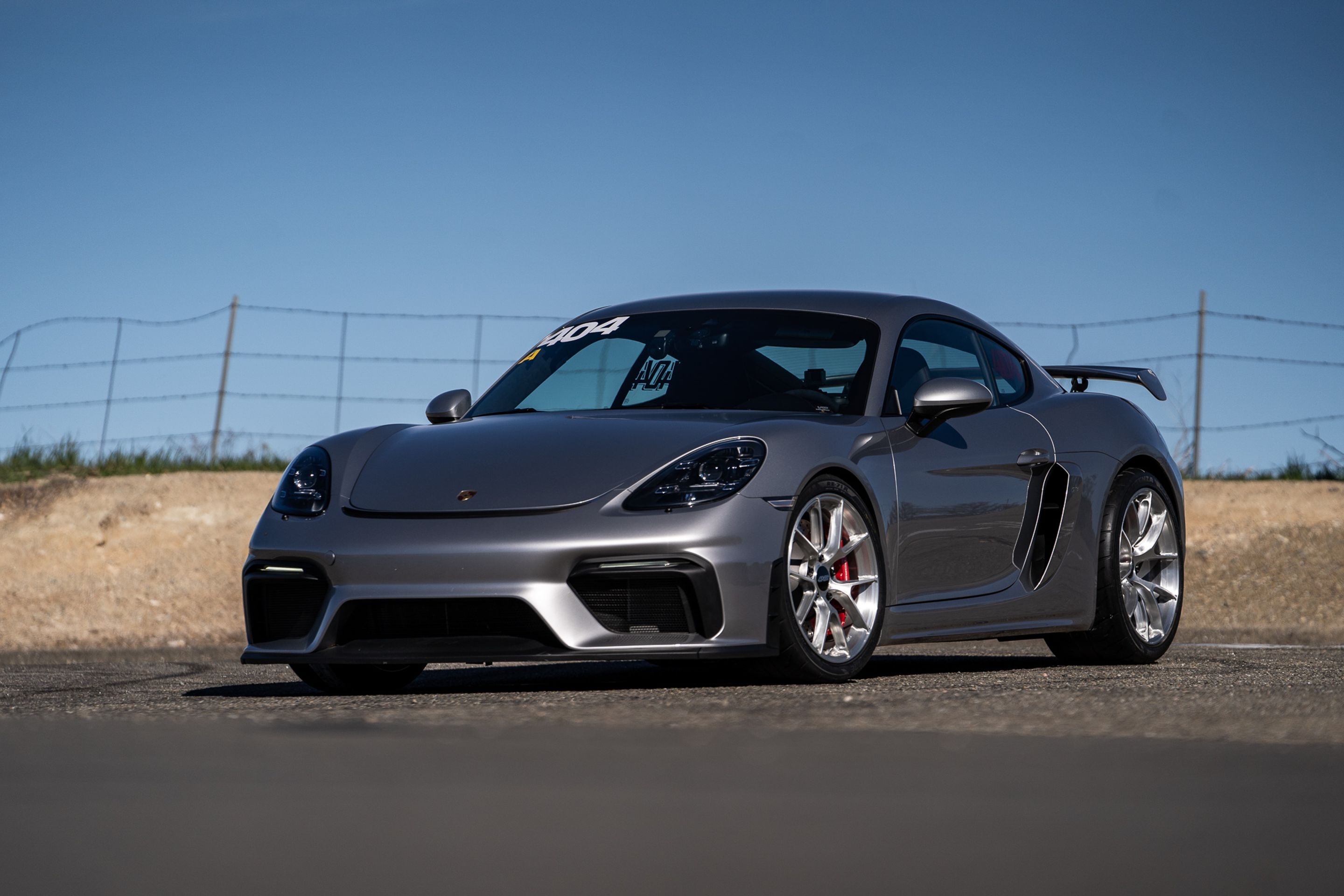 Grey Porsche 718 Cayman GT4 with 19" VS-5RS Apex wheels in Brushed Clear