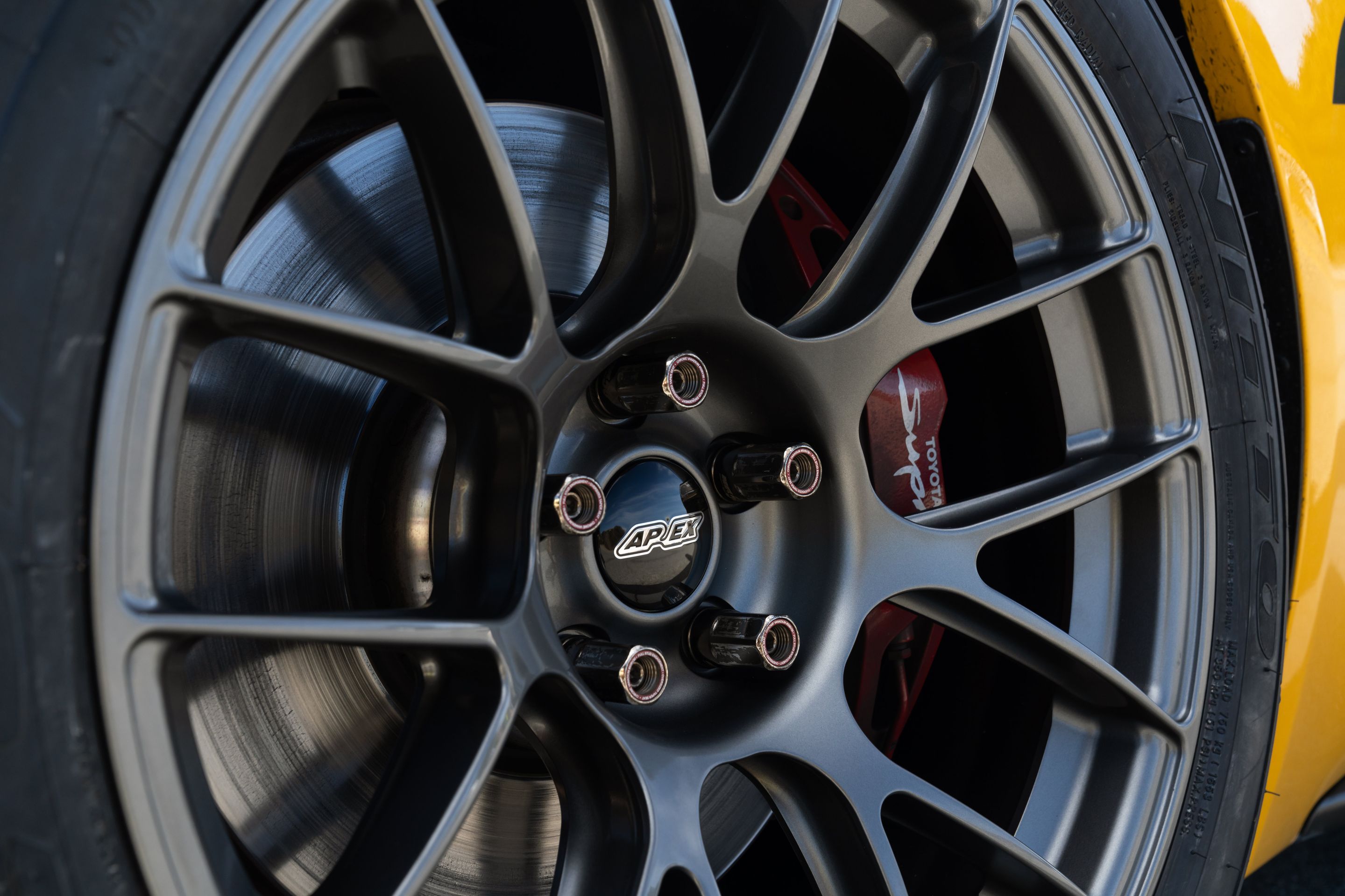 Yellow Toyota GR Supra with 18" EC-7RS Apex wheels in Anthracite