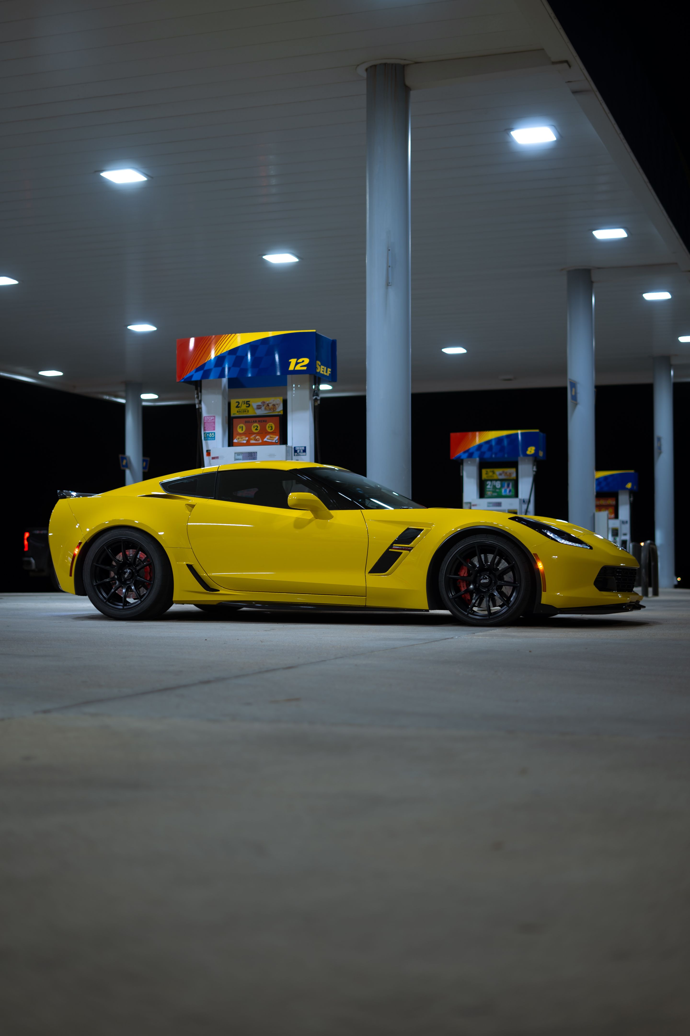 Yellow Chevrolet C7 Corvette Grand Sport with 19" SM-10 Apex wheels in Satin Black