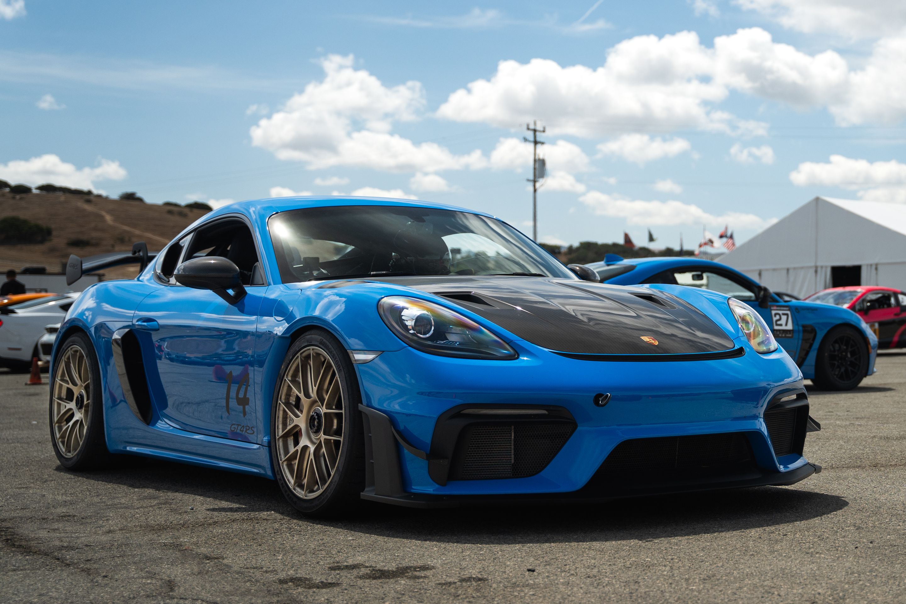 Blue Porsche 718 Cayman GT4 RS with 19" EC-7RS Apex wheels in Motorsport Gold