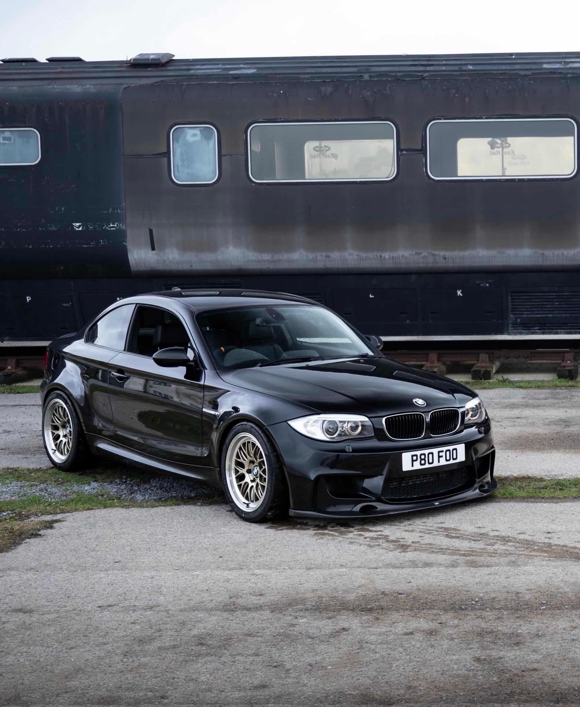 Black BMW E82 1M with 18" ML-10RT Apex wheels in Machined Lip Gloss Motorsport Gold
