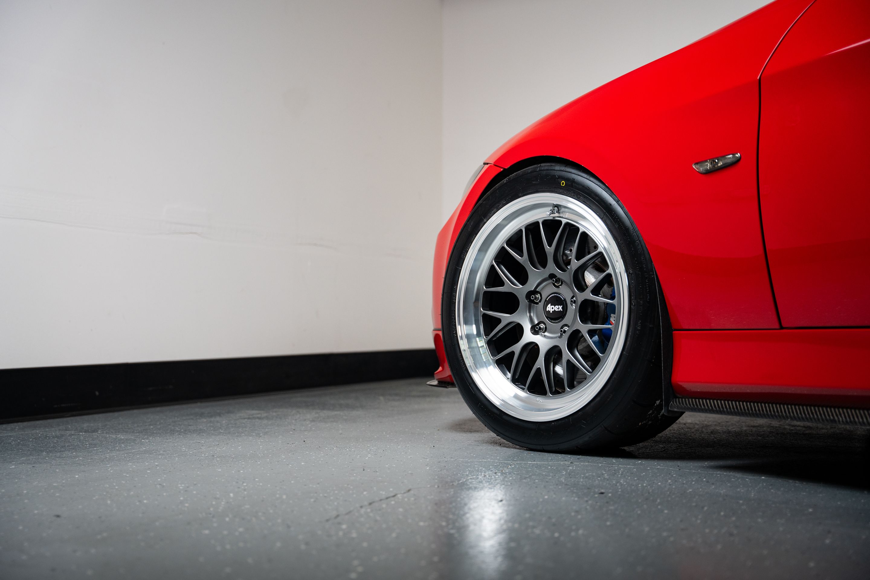 Red BMW E90 Sedan 3 Series with 18" ML-10RT Apex wheels in Machined Lip Anthracite
