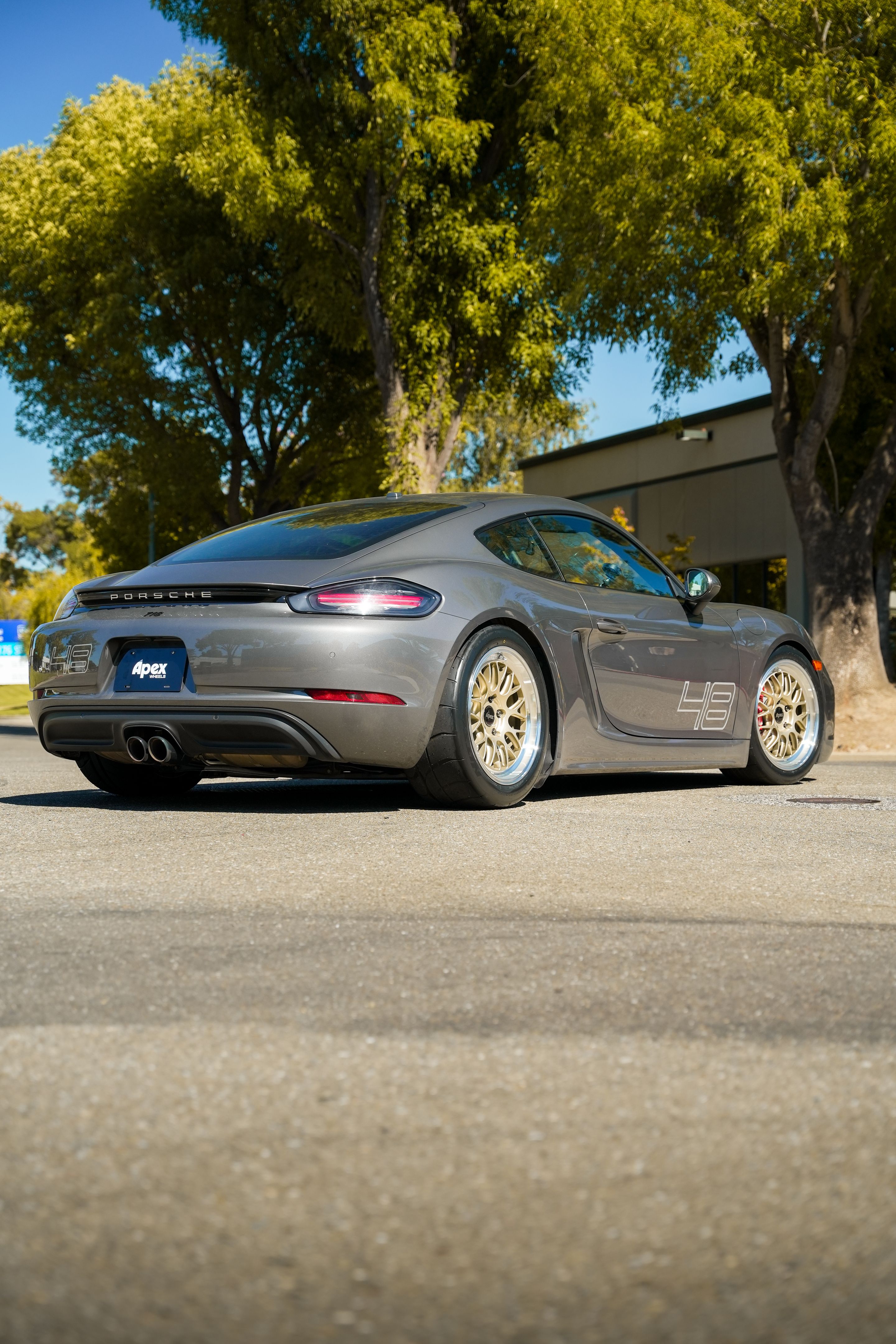 Grey Porsche 718 Cayman S with 18" ML-10RT Apex wheels in Machined Lip Gloss Motorsport Gold