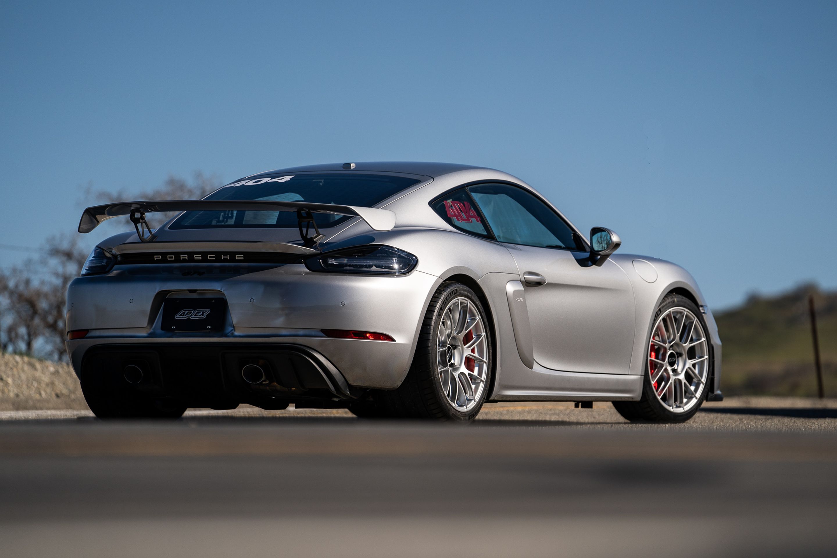 Grey Porsche 718 Cayman GT4 with 19" EC-7RS Apex wheels in Race Silver