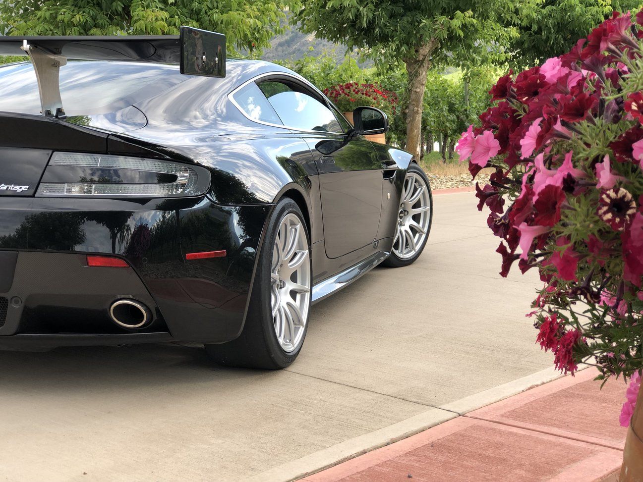 Black Aston Martin V8/V12 Vantage with 19" SM-10 Apex wheels in Race Silver