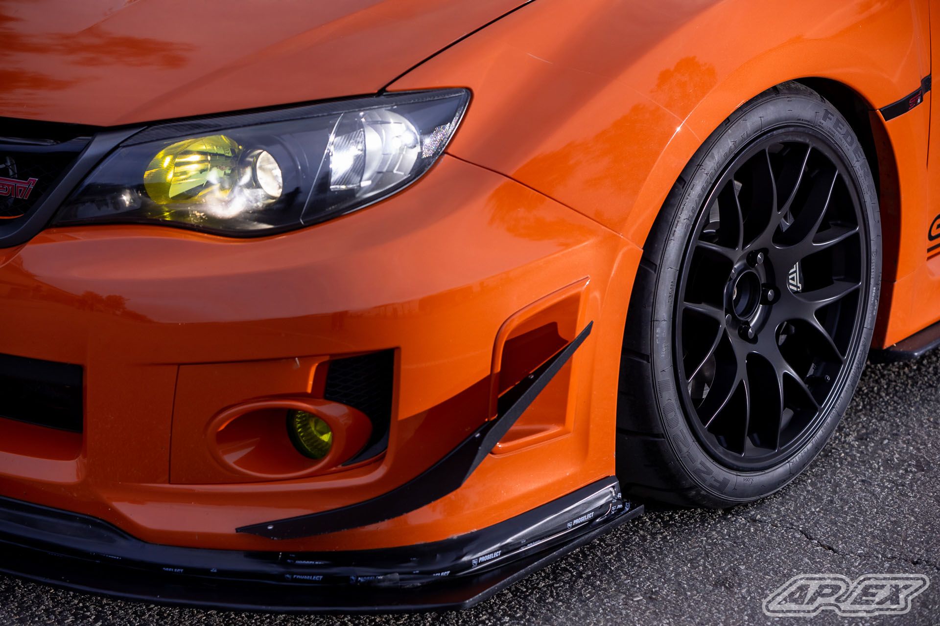 Orange Subaru GR WRX STI with 18" EC-7 Apex wheels in Satin Black