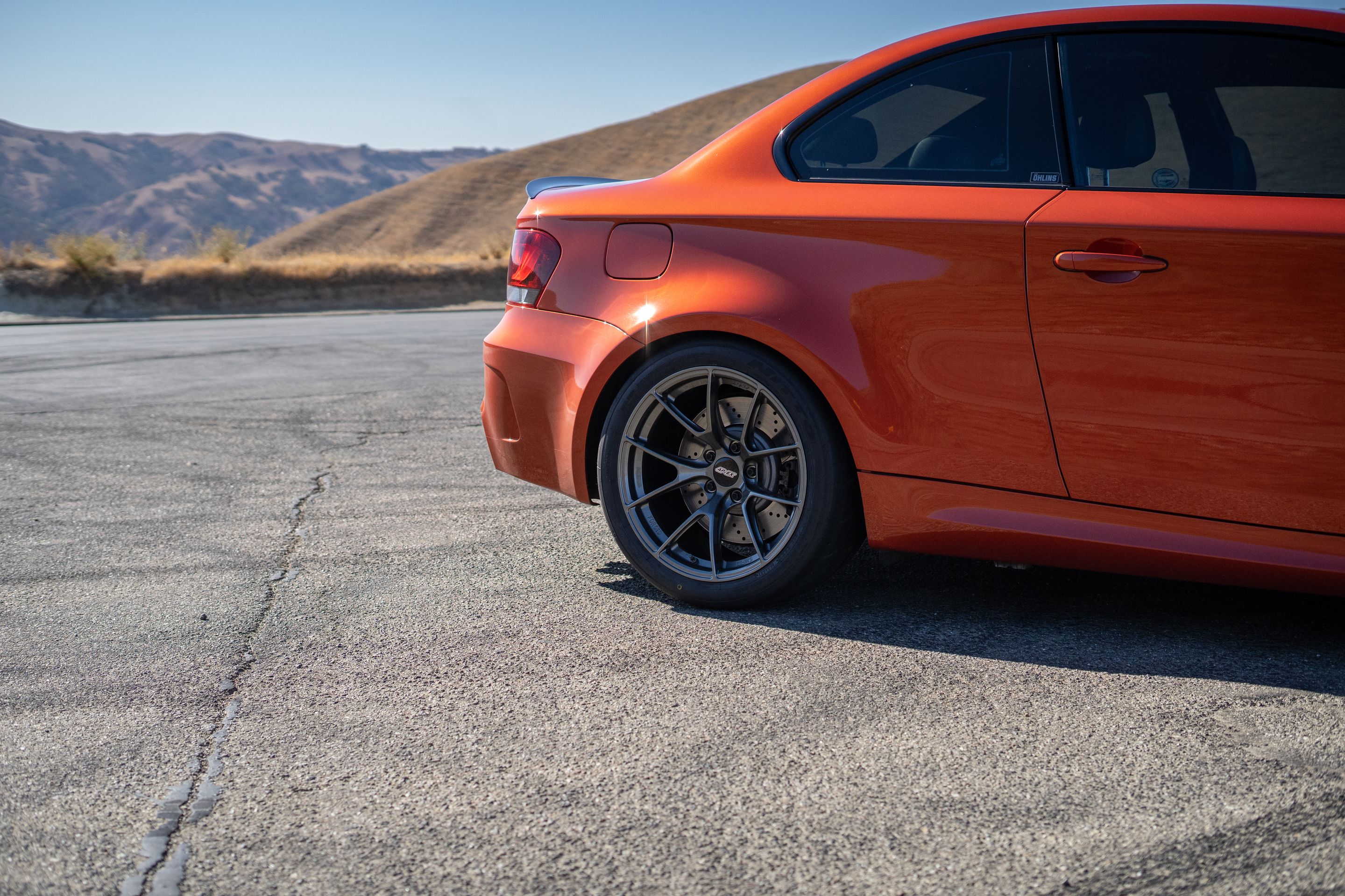 Orange BMW E82 1M with 18" VS-5RS Apex wheels in Anthracite