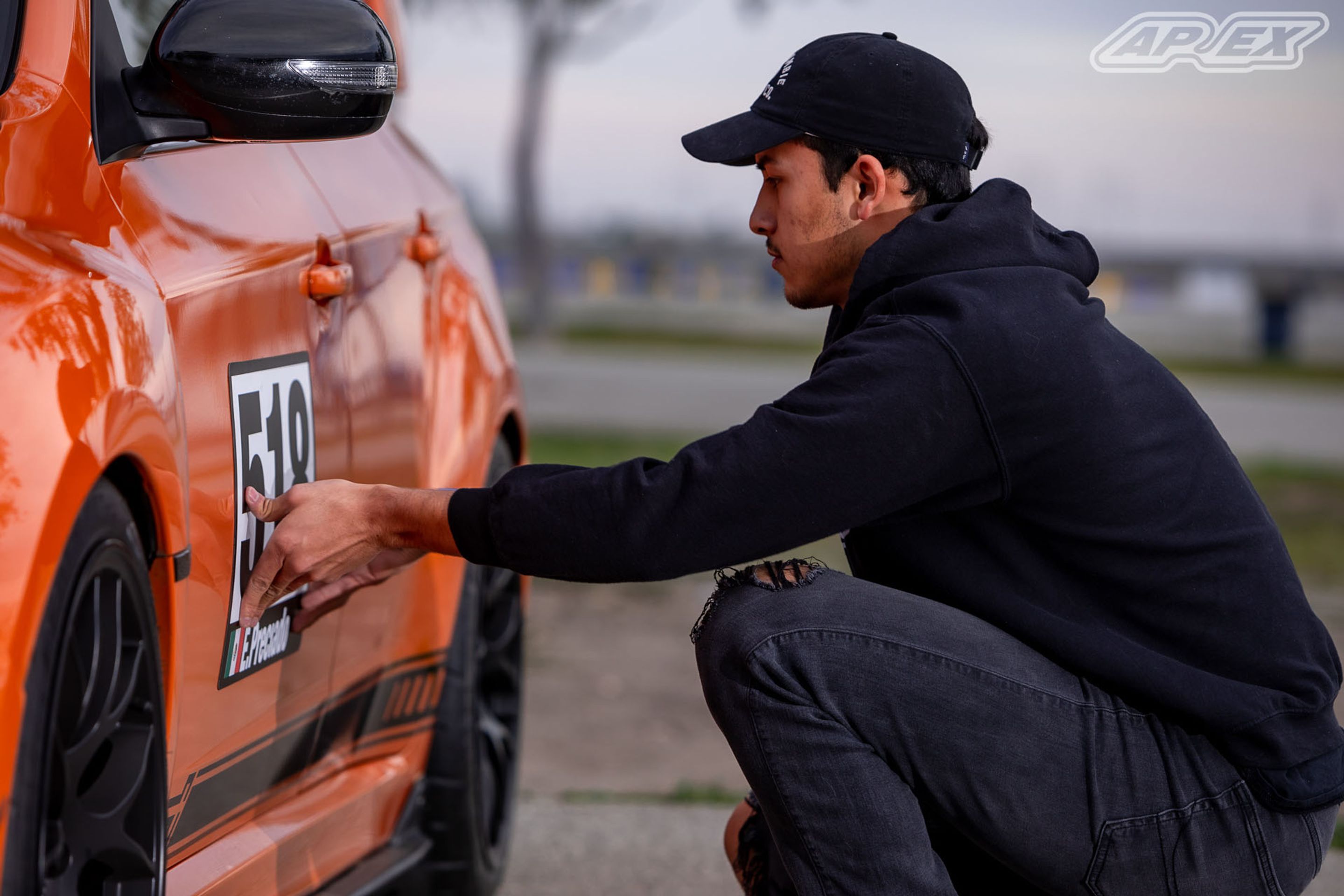 Orange Subaru GR WRX STI with 18" EC-7 Apex wheels in Satin Black