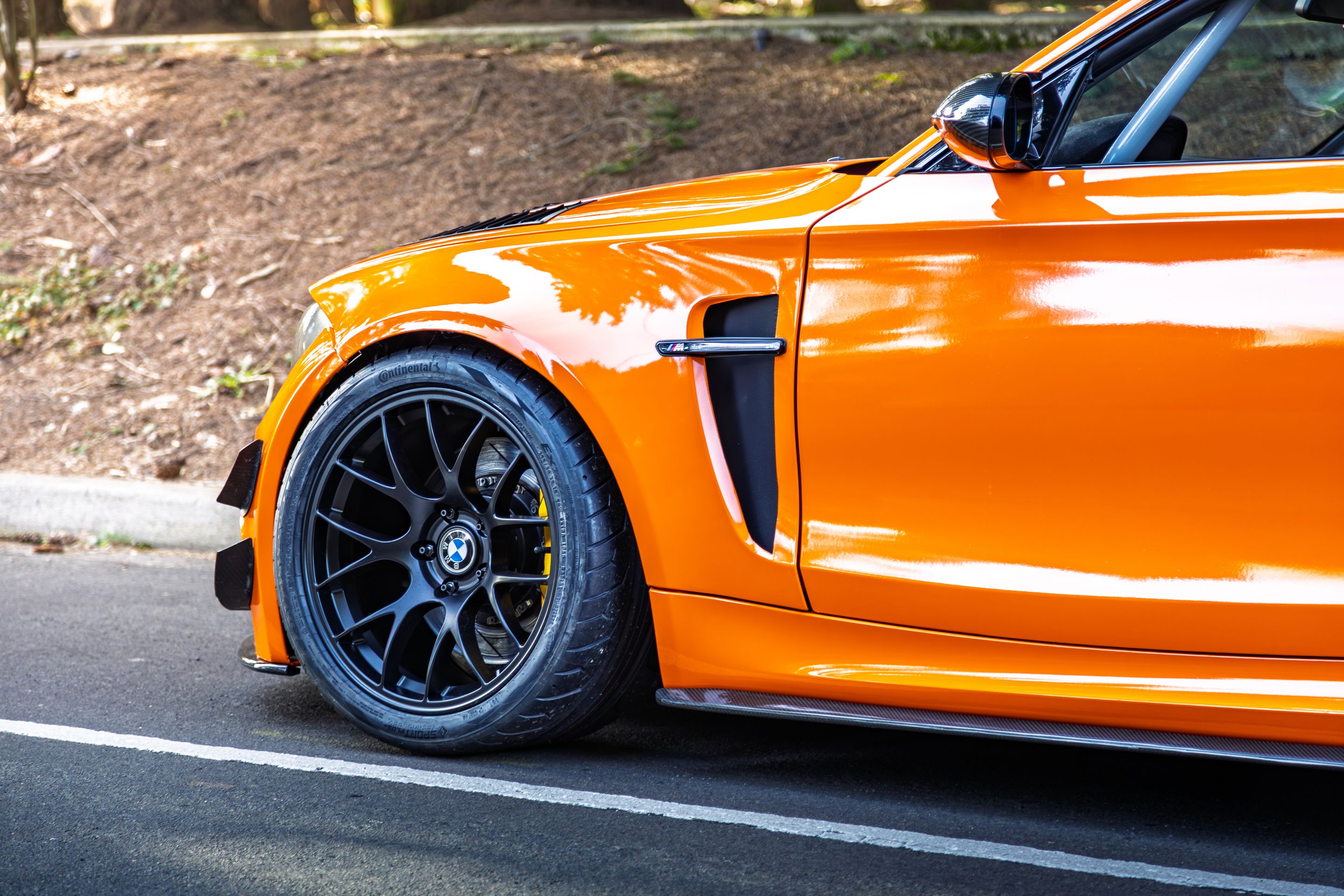 Orange BMW E82 1M with 18" EC-7 Apex wheels in Satin Black