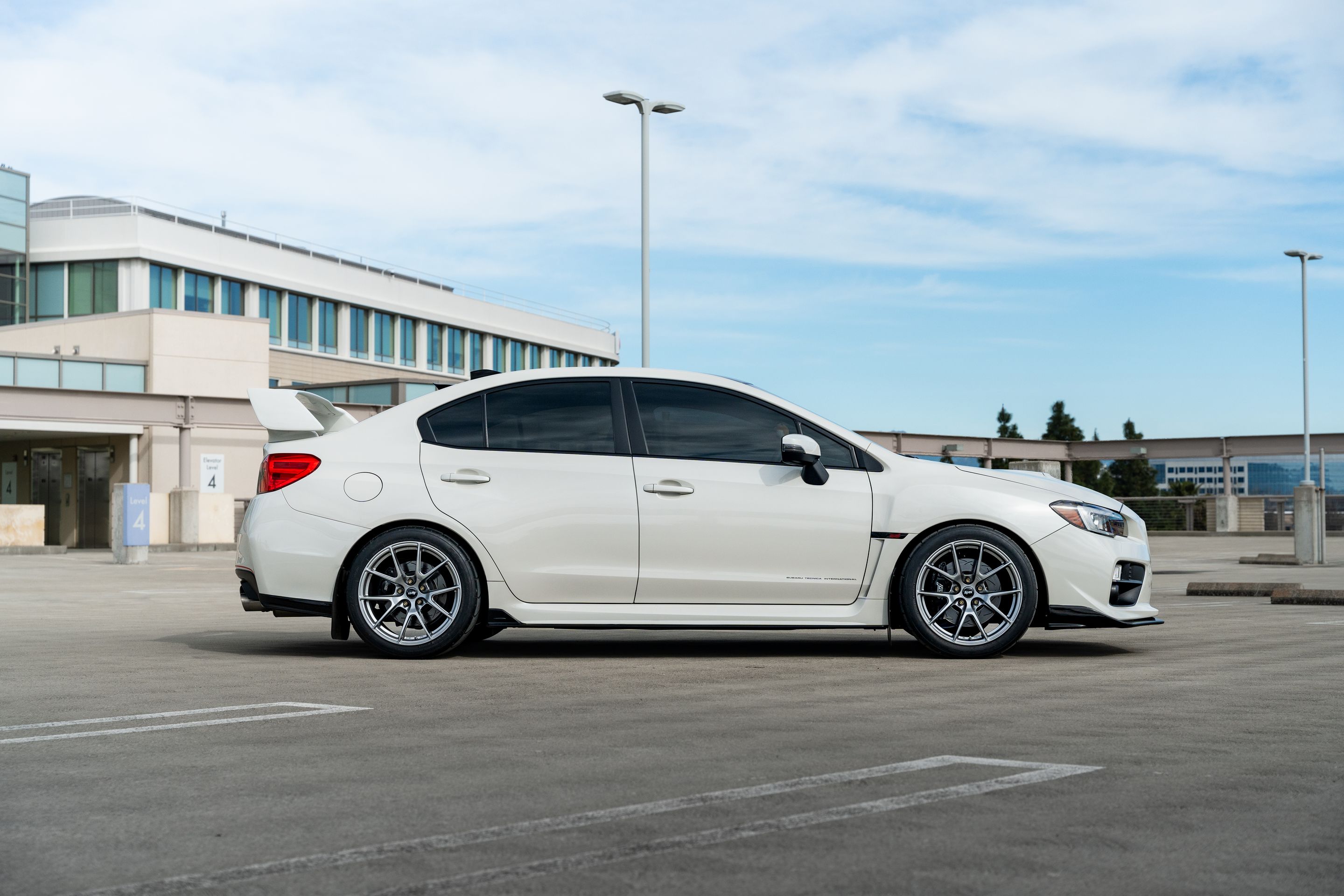 White Subaru VA WRX STI with 18" VS-5 Apex wheels in Hyper Black