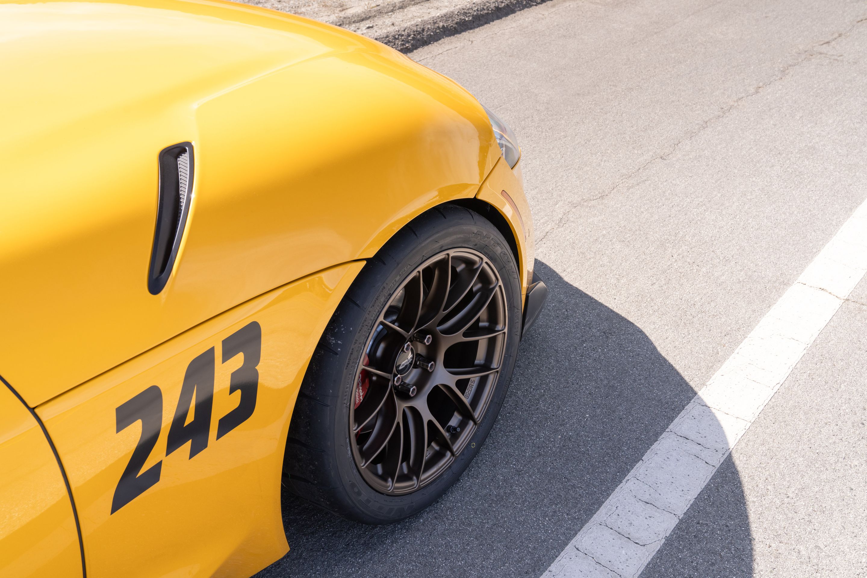 Yellow Toyota GR Supra with 18" EC-7RS Apex wheels in Satin Bronze