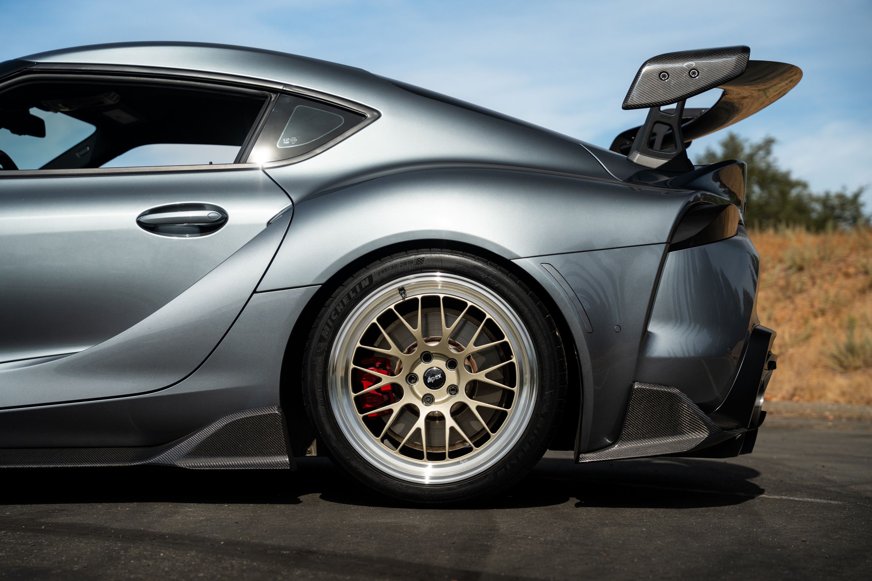 Grey Toyota GR Supra with 19" ML-10RT Apex wheels in Machined Lip Gloss Motorsport Gold