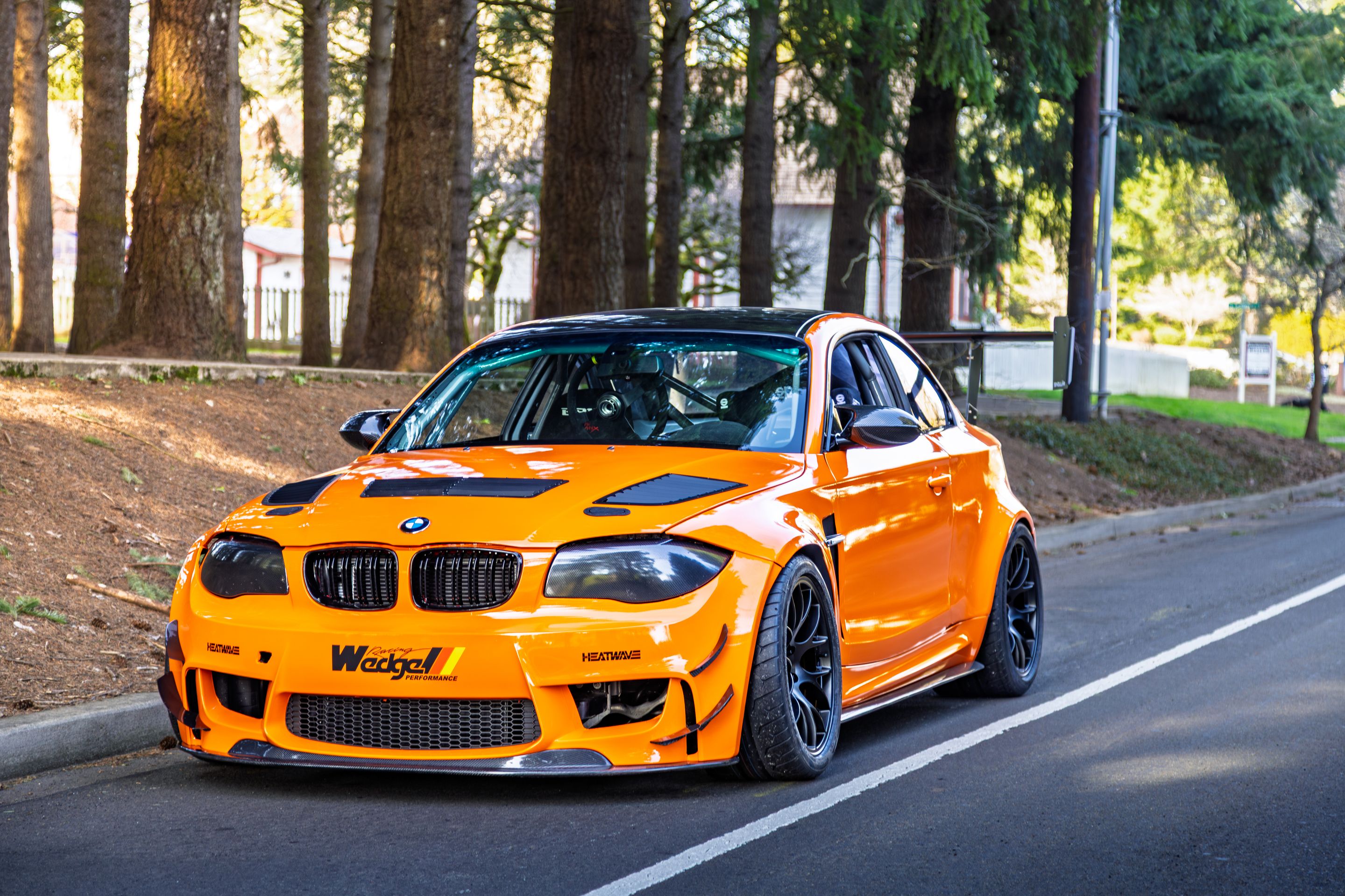 Orange BMW E82 1M with 18" EC-7 Apex wheels in Satin Black