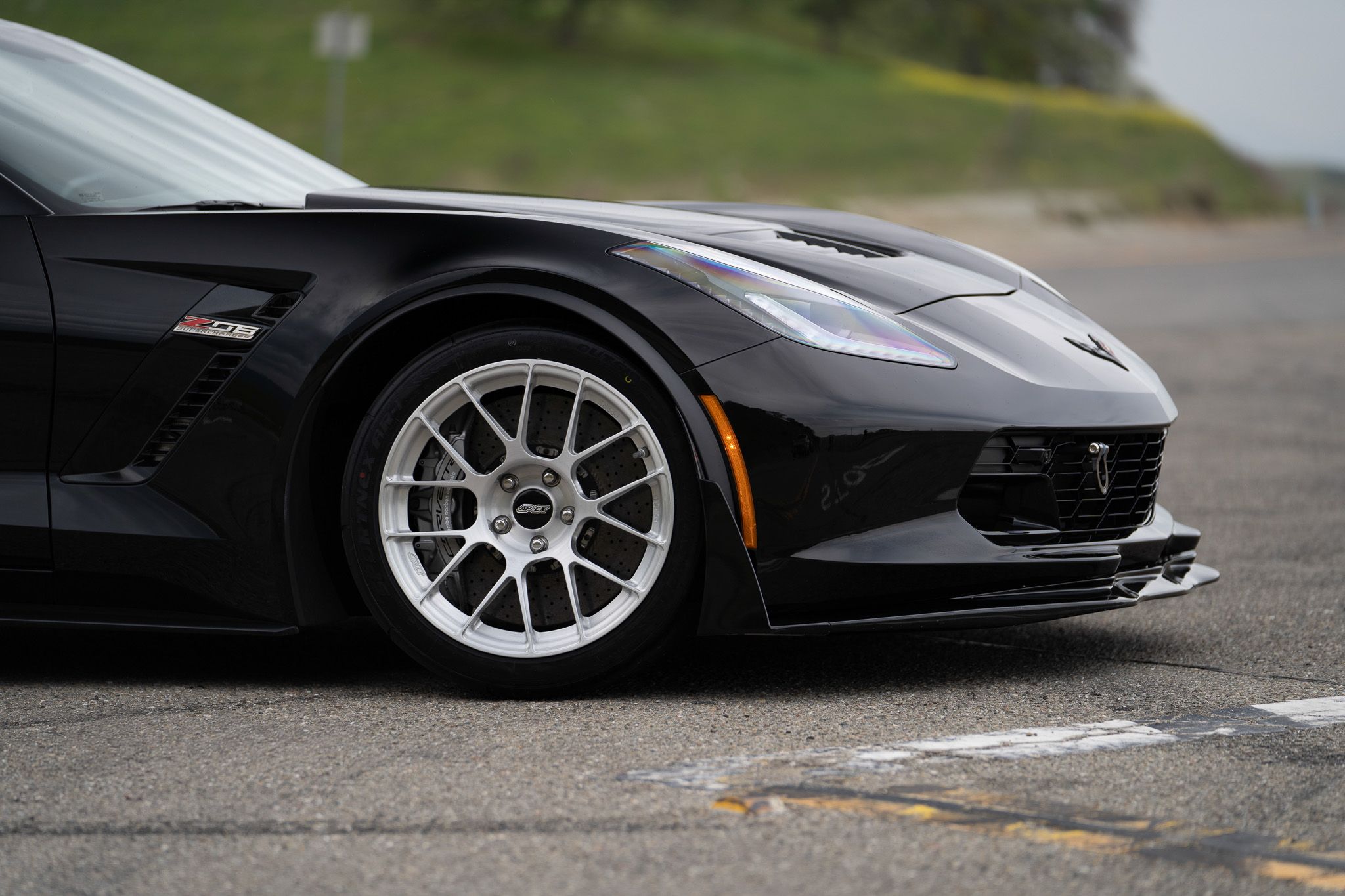 Black Chevrolet C7 Corvette Z06 with 18"/19" EC-7RS Apex wheels in Brushed Clear