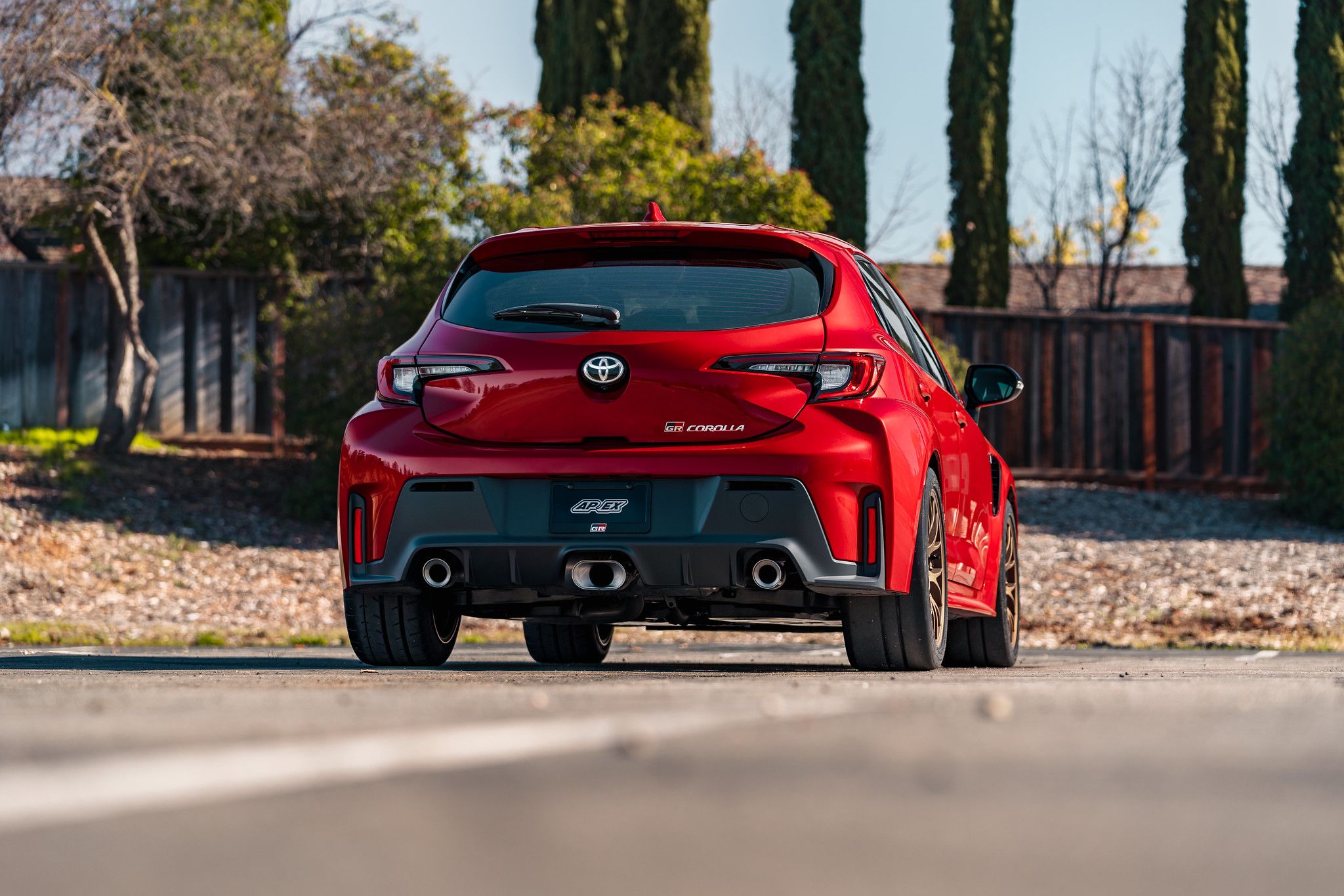 Red Toyota GR Corolla with 18" EC-7 Apex wheels in Satin Bronze