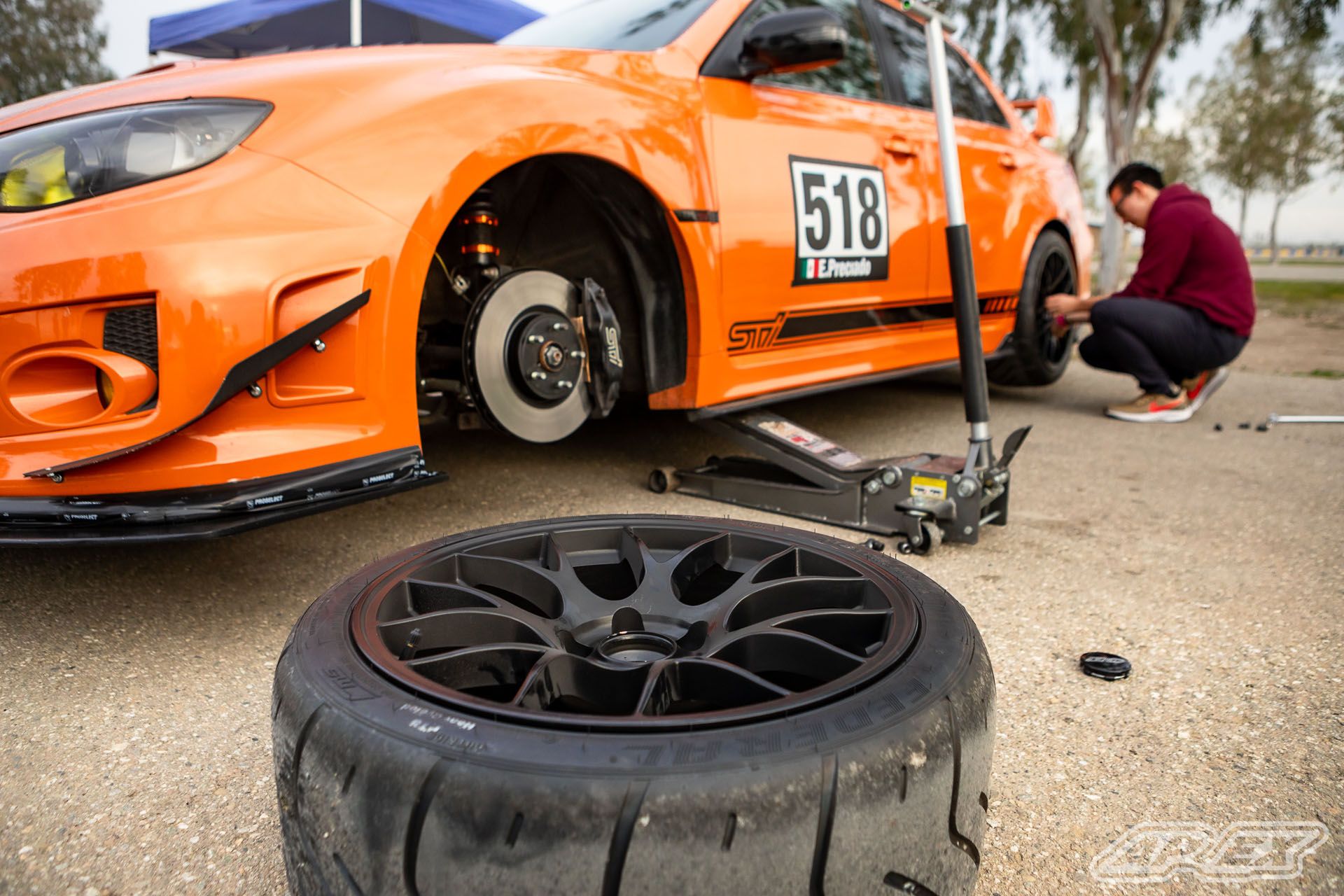 Orange Subaru GR WRX STI with 18" EC-7 Apex wheels in Satin Black
