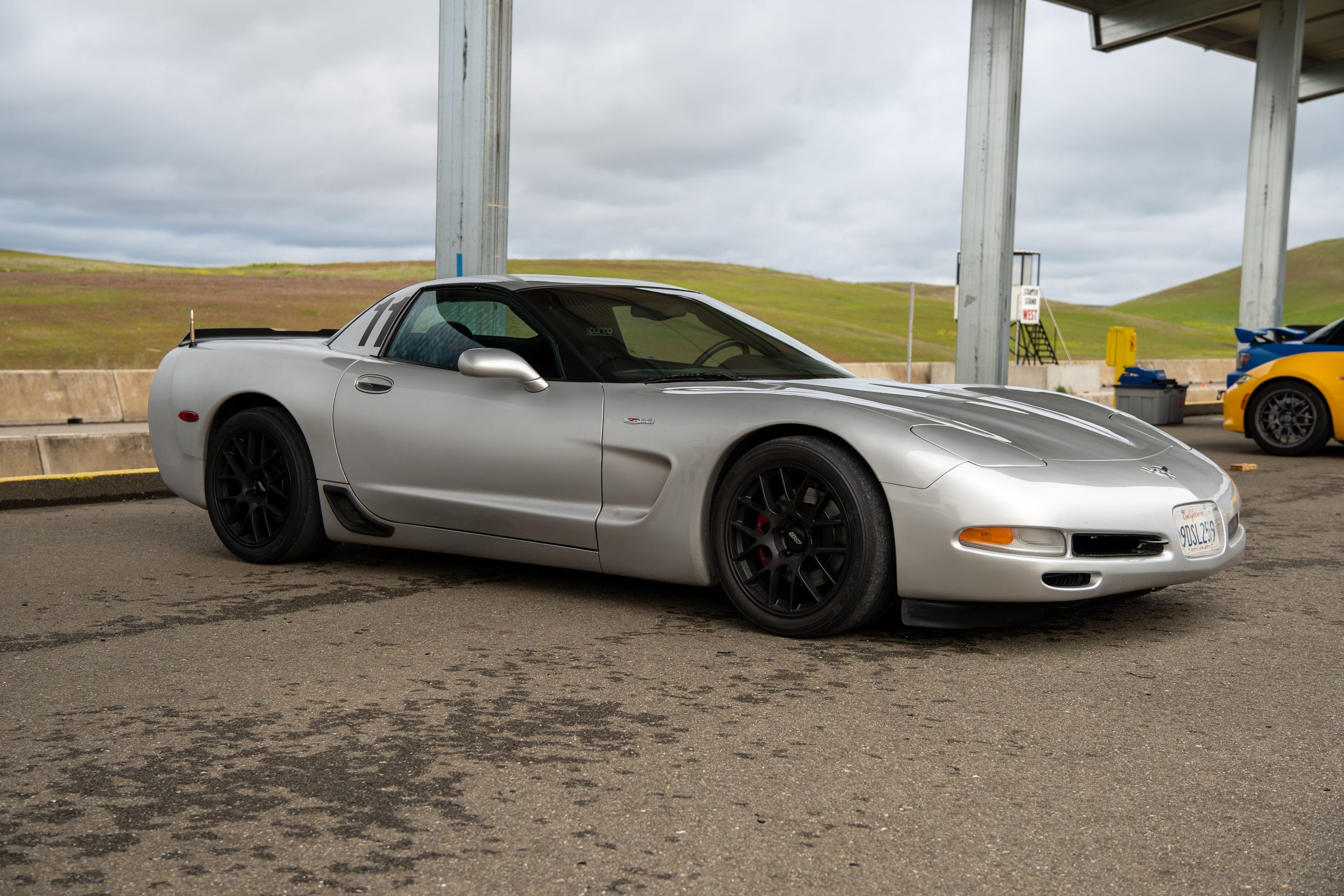 Silver Chevrolet C5 Corvette Z06 with 18" EC-7 Apex wheels in Satin Black