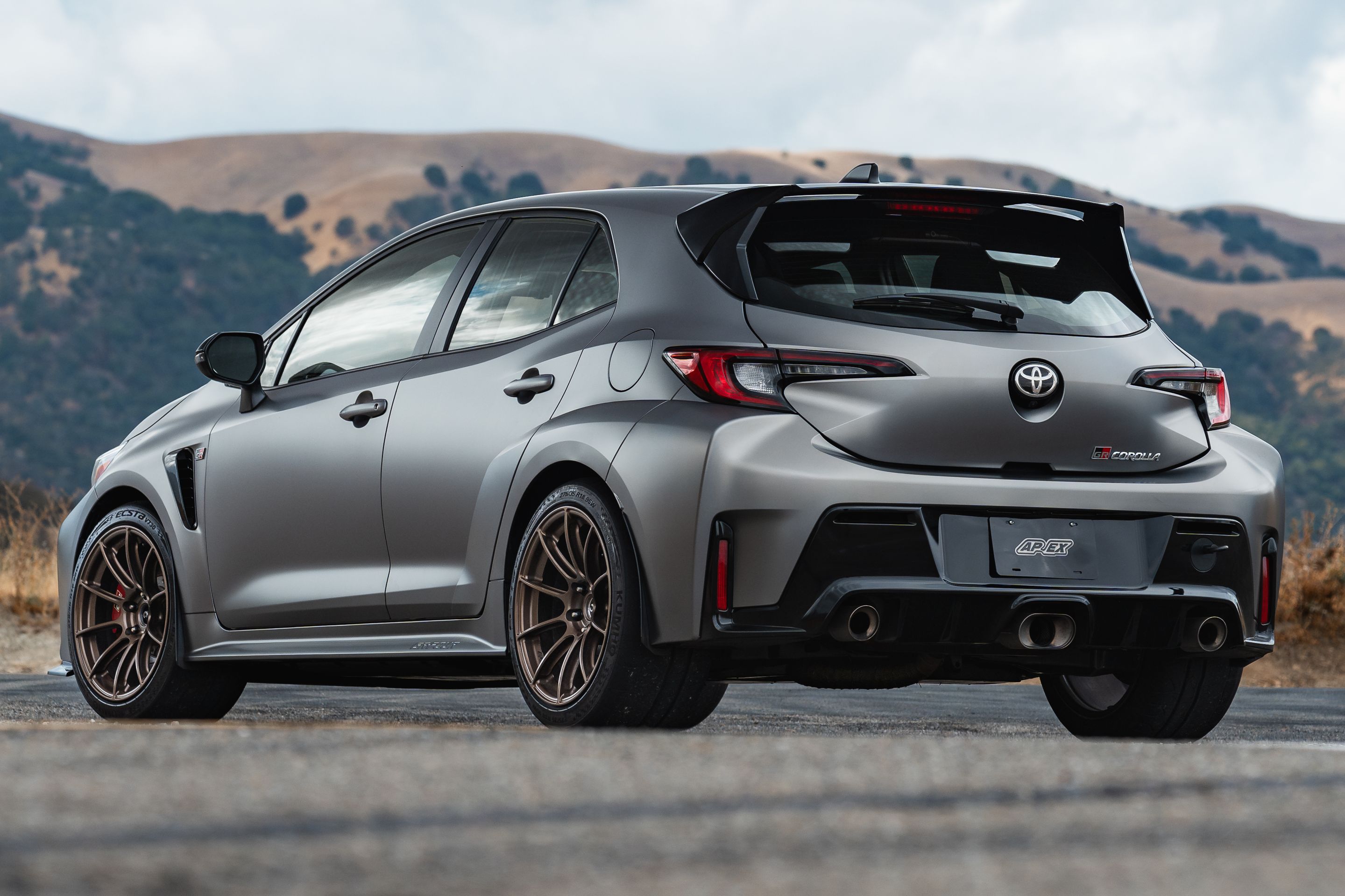 Grey Toyota GR Corolla with 18" SM-10RS Apex wheels in Satin Bronze