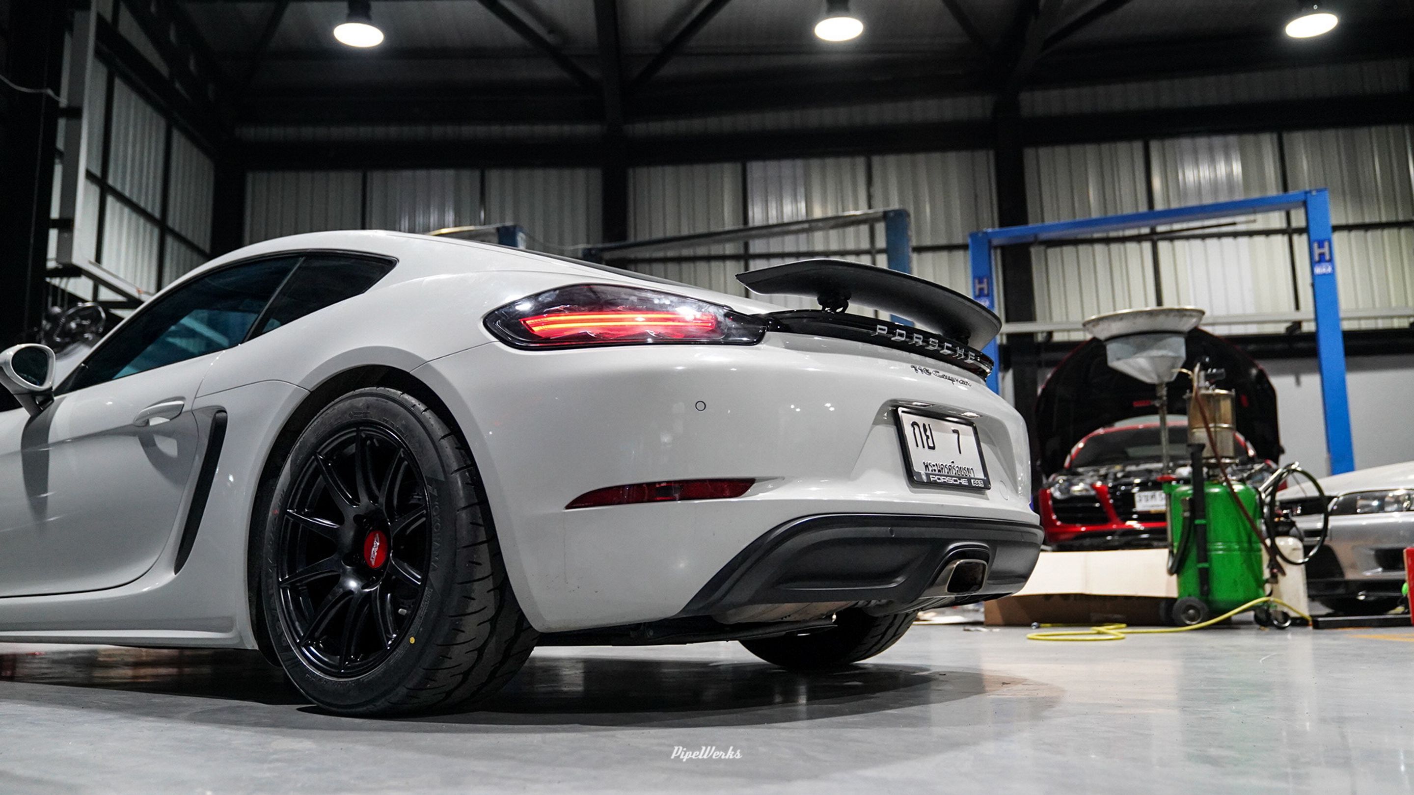 White Porsche 718 Cayman Base with 18" SM-10 Apex wheels in Satin Black