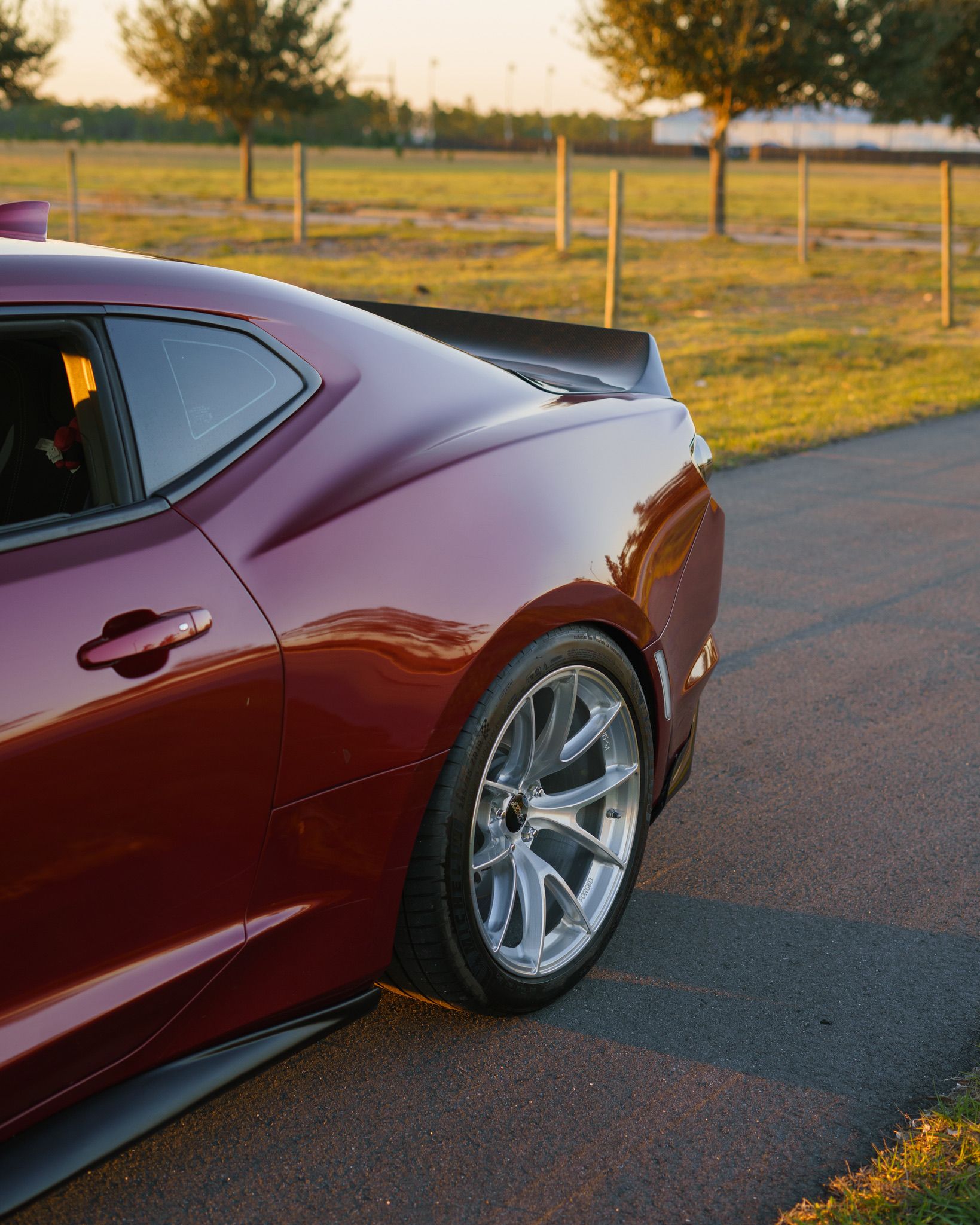 Red Chevrolet 6th Gen Camaro LT1 with 19" VS-5RS Apex wheels in Brushed Clear