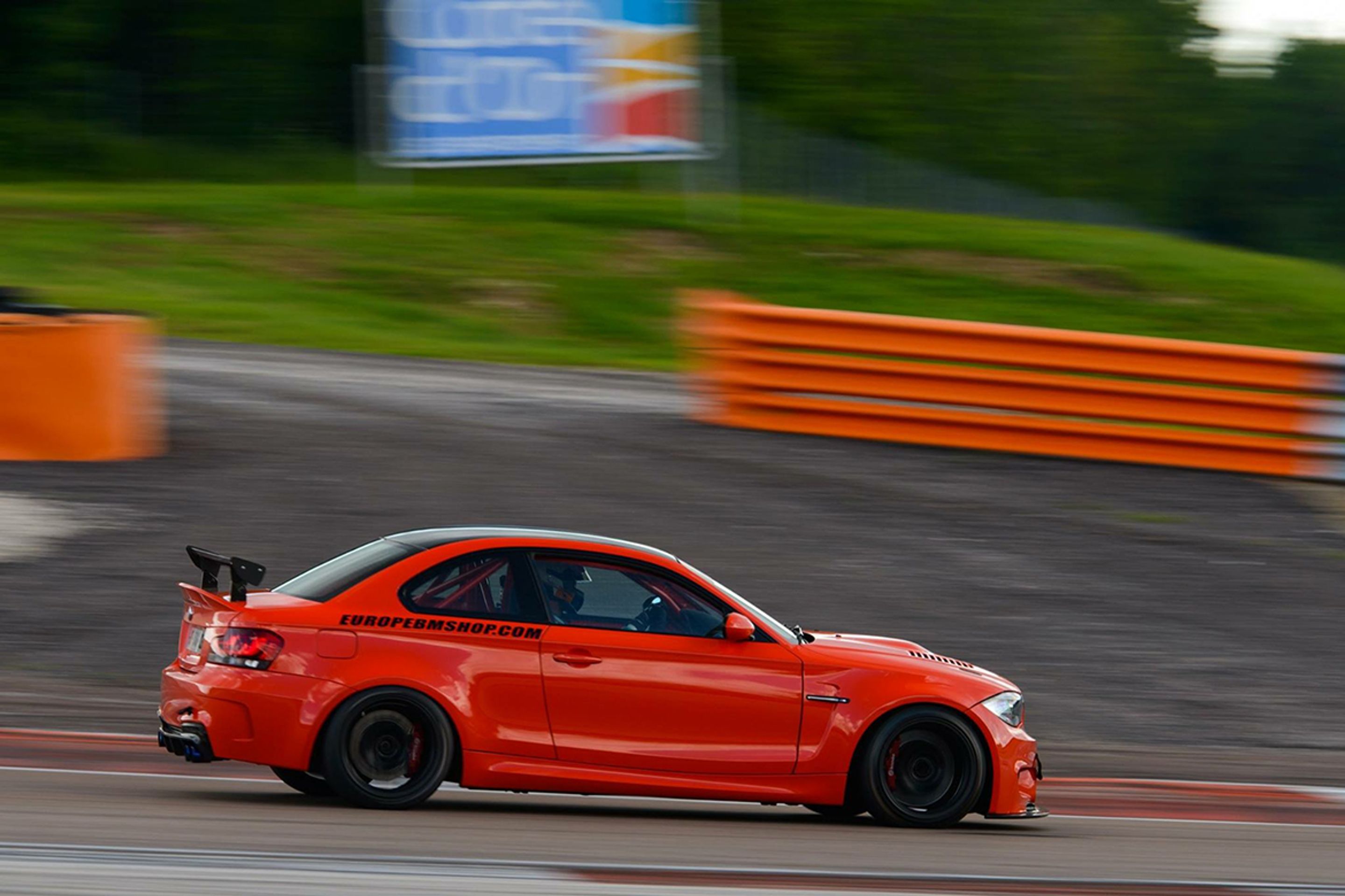 Orange BMW E82 1M with 18" EC-7 Apex wheels in Satin Black
