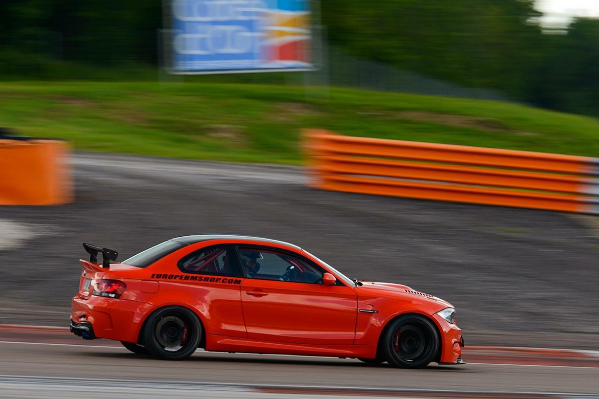 Orange BMW E82 1M with 18" EC-7 Apex wheels in Satin Black