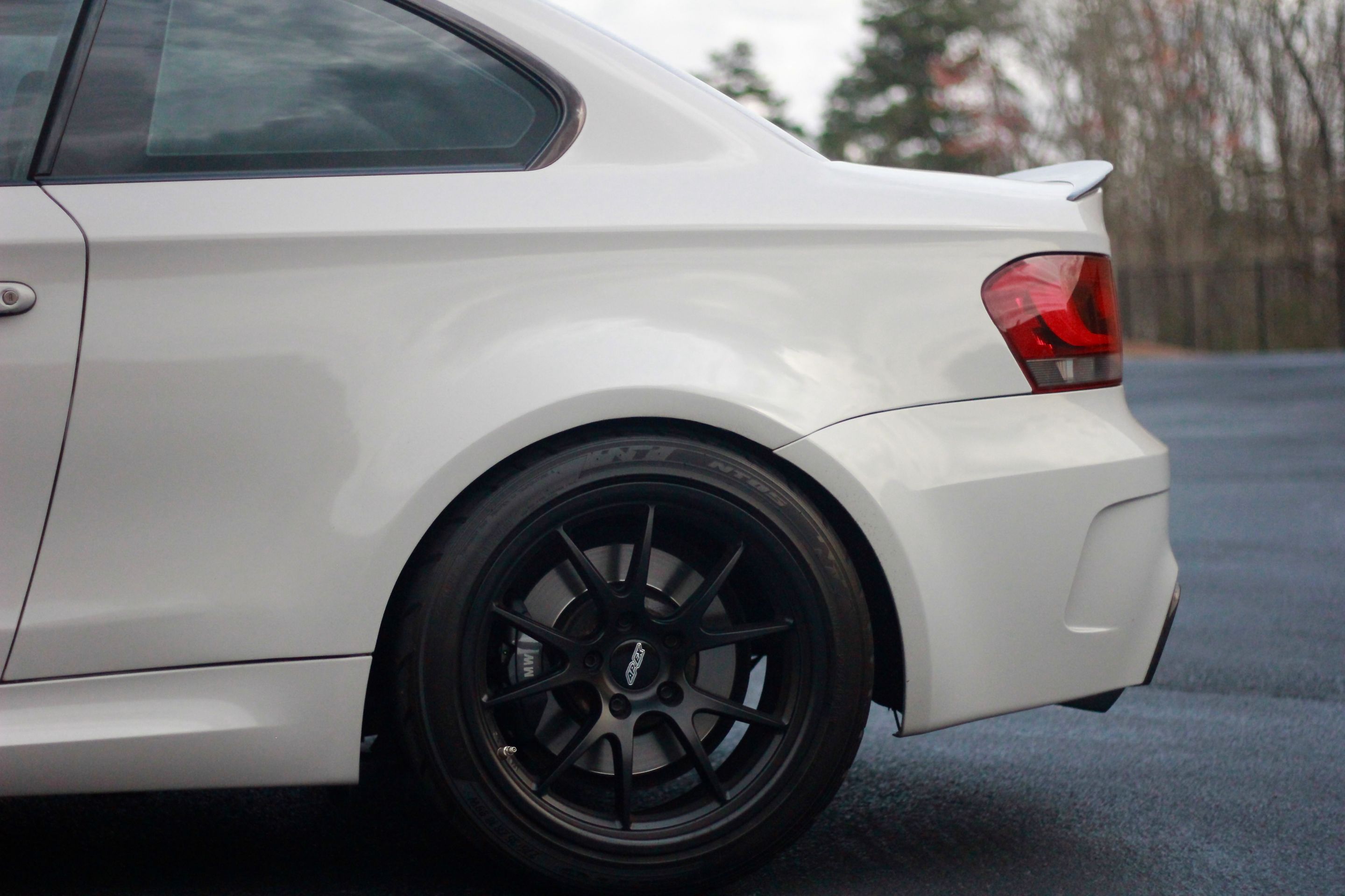 White BMW E82 1M with 18" FL-5 Apex wheels in Satin Black