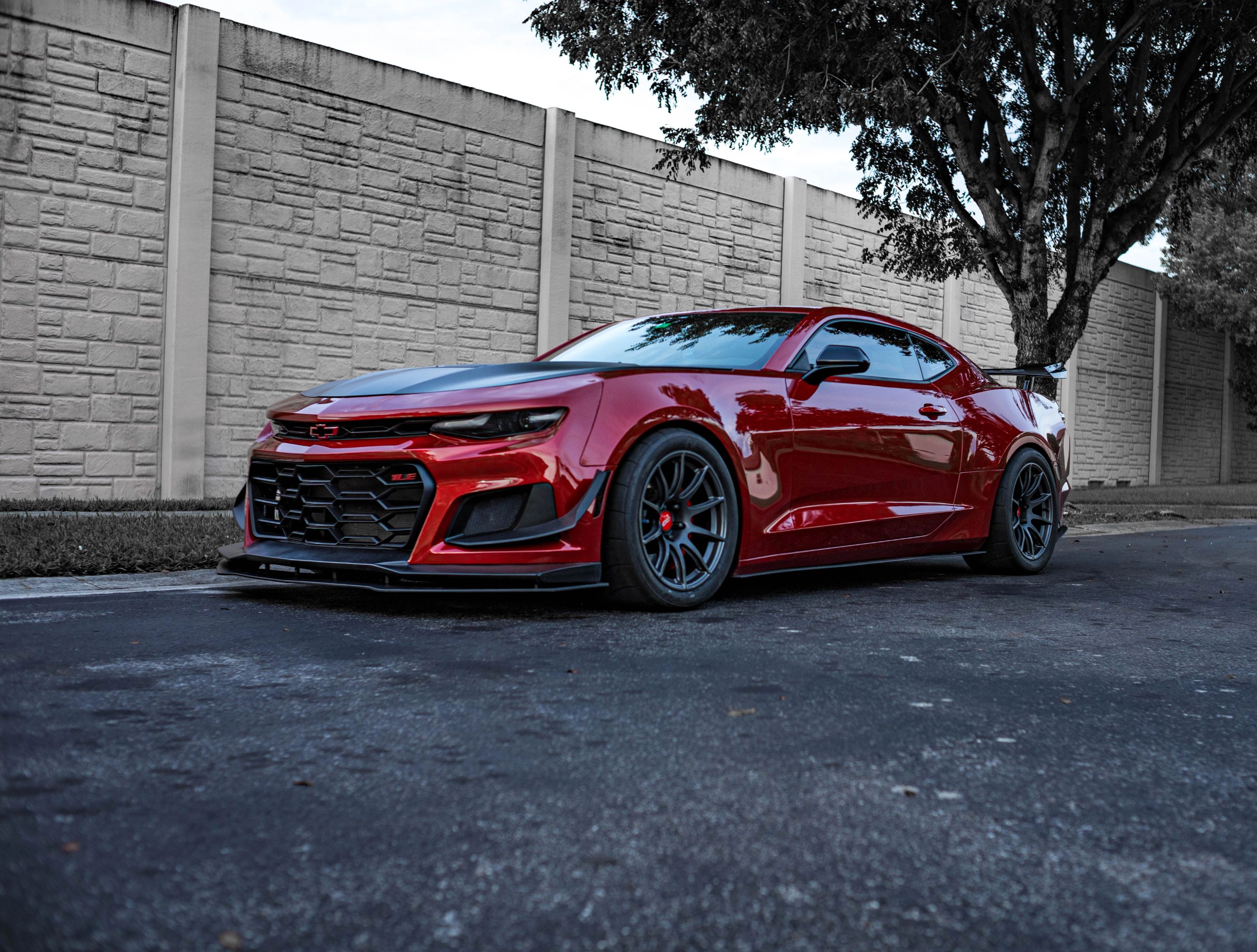 Red Chevrolet 6th Gen Camaro SS with 19" SM-10 Apex wheels in Satin Black