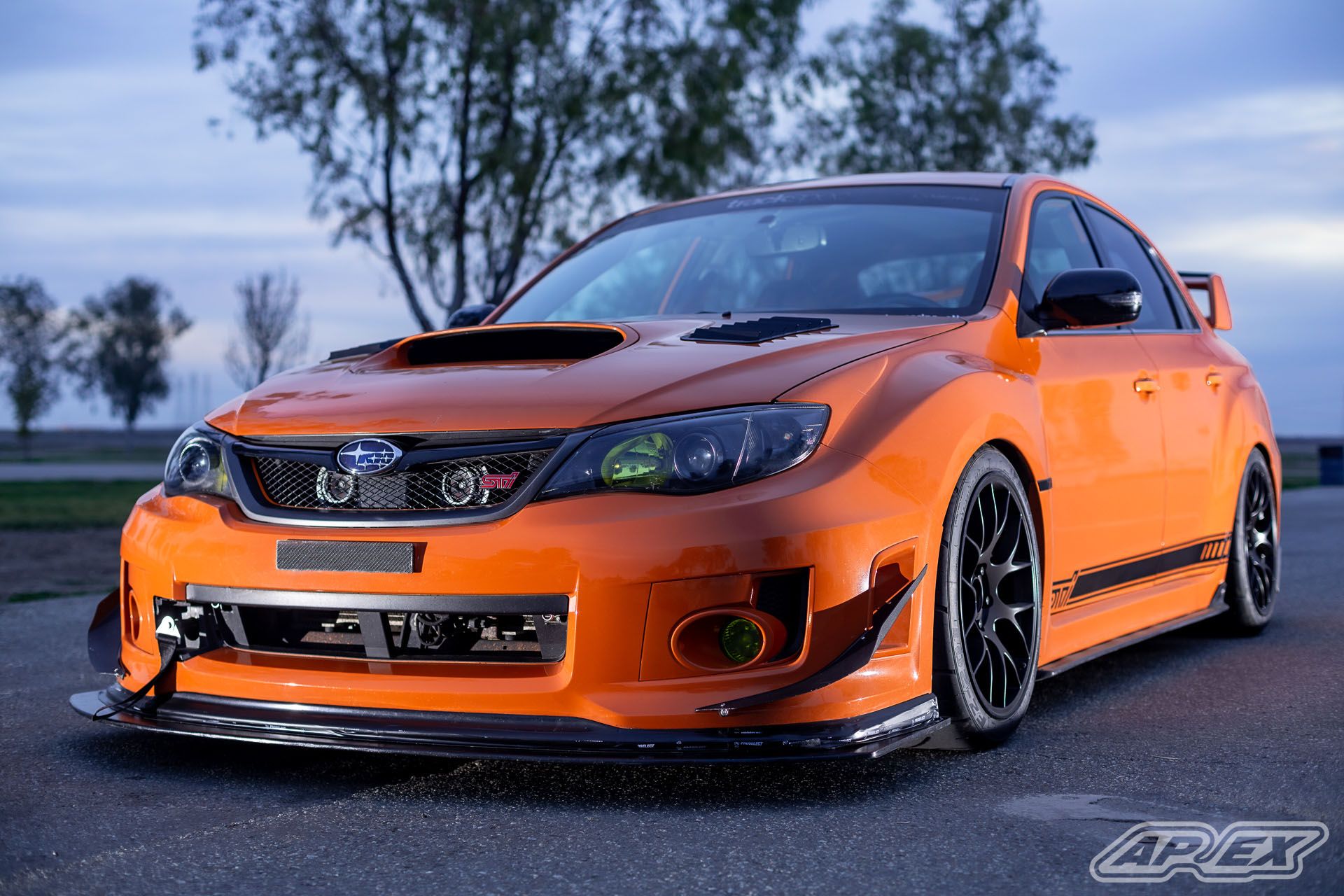Orange Subaru GR WRX STI with 18" EC-7 Apex wheels in Satin Black