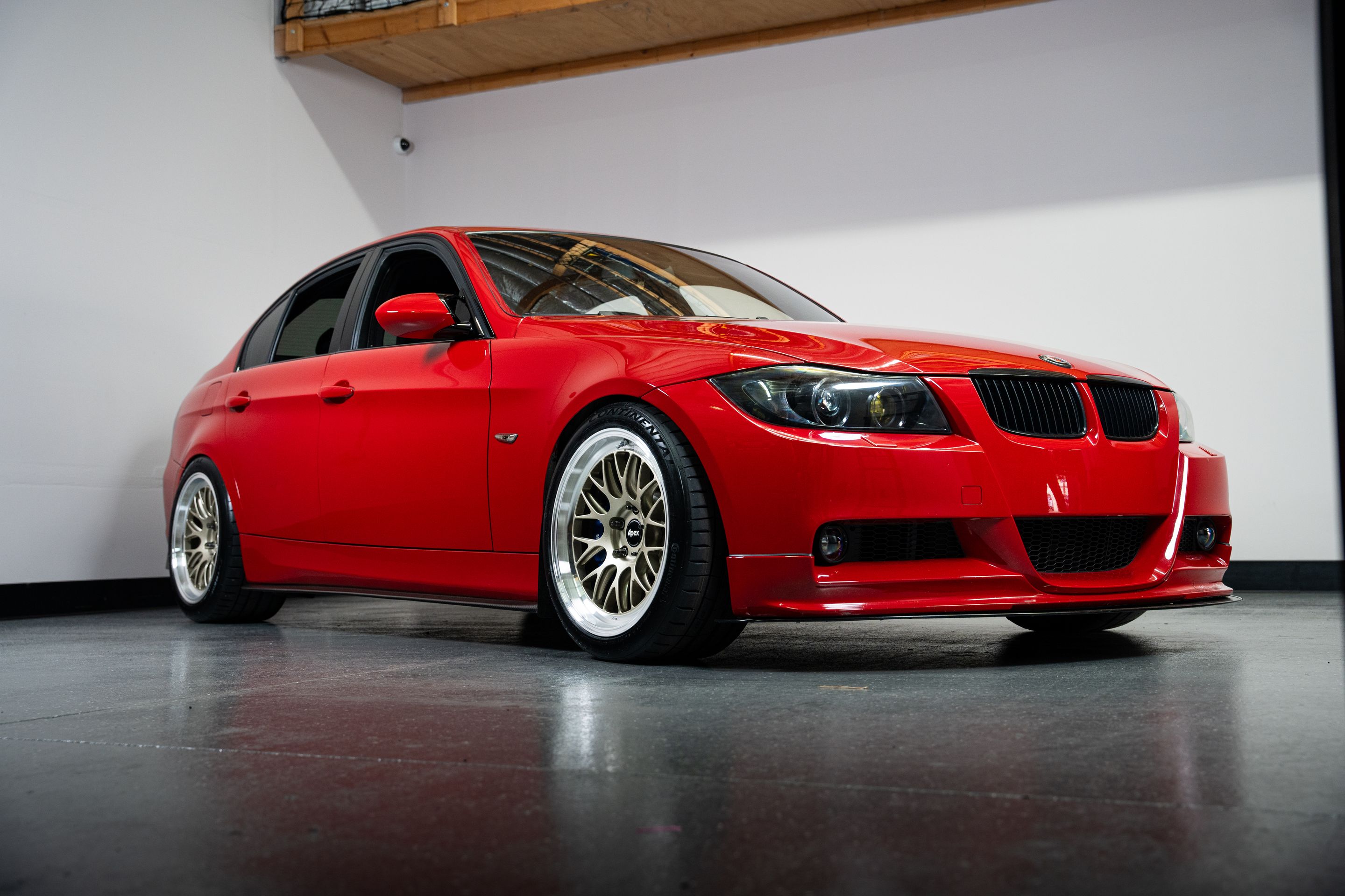 Red BMW E90 Sedan 3 Series with 18" ML-10RT Apex wheels in Machined Lip Gloss Motorsport Gold